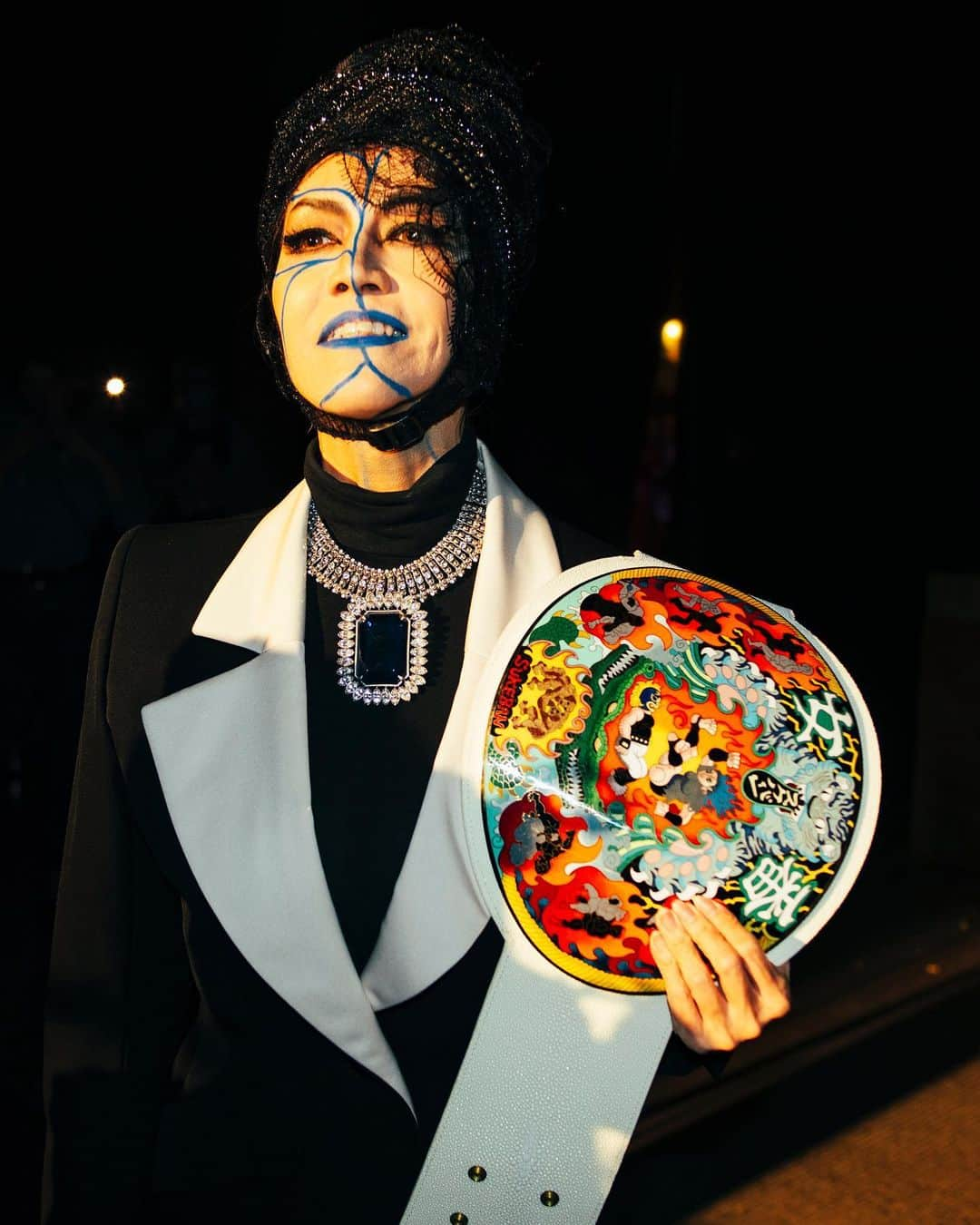 オランピアルタンのインスタグラム：「Bull Nakano presenting the @sukeban_world Championship Belt in NYC, wearing vintage YSL and a @stephenjonesmillinery custom made hat. 🖤🏆🤼‍♀️🎌 @bull__nakano  Sukeban World Championship Belt designed by @marcnewsonofficial with an illustration by @ishiguroayako  📸 @jirokonami」