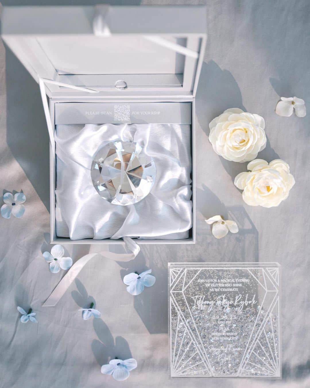 Ceci Johnsonのインスタグラム：「BIRTHDAY | Inspired by the diamond theme, we dreamed up for Tiffany a special couture invitation to commemorate her 3rd birthday milestone. As you open the box, a glass diamond, engraved with the initial T, rests atop a silver silk base, symbolizing the wish to 'shine bright like a diamond’. Inside the box's lid reveals a transparent acrylic invitation filled with diamonds and glitter cascading freely within. Every detail of the dreamy invitation is made by hand and a lot of love for Tiffany and the Rybak family.   Swipe to the end for a cute surprise of the birthday girl sitting in her life-size invitation! #CeciCouture  ⠀⠀⠀⠀⠀⠀⠀⠀⠀ CREATIVE PARTNERS Invitation Design: @cecinewyork Event planner: @amgeventsandvisuals  Event design: @aramatevents ⠀⠀⠀⠀⠀⠀⠀⠀⠀ Swipe to the end for a little cute surprise 🎁   #cecibirthday #coutureinvitations #birthdayprincess #shininginvitation #shinebrightlikeadiamond #luxuryinvitations #kidsbirthday」