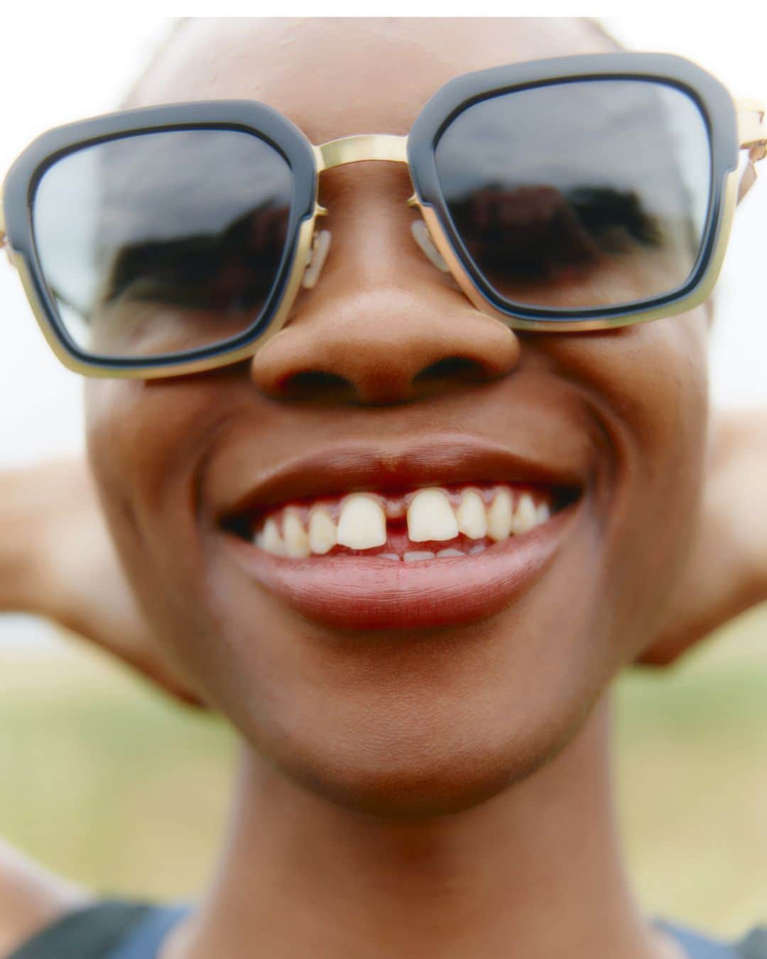 MYKITAのインスタグラム：「With that megawatt smile and style – Tumi @tumininu.f.k_wears MISTY in Glossy Gold/Milky Indigo. Handmade from circular materials at the MYKITA HAUS in Berlin.  Available now online at mykita.com, in our MYKITA Shops and selected retailers worldwide.  Photography by Ben Beagent @ben088  #mykita」