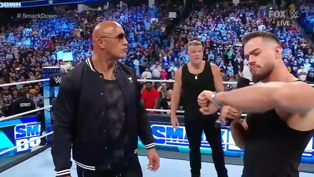 ドウェイン・ジョンソンのインスタグラム：「I’m known to be a straight shooter and speak from the heart 🖤 🤣  Rock mic in hand 🎤🖐🏾  LIVE on TV 📺  On the show that was named in my honor 🙏🏾 #SMACKDOWN 💪🏾  Having way too much fun!!  Luv U back @wwe universe   ~ people’s champ ✊🏾  @austin_theory 🥃 @patmcafeeshow 🥃」