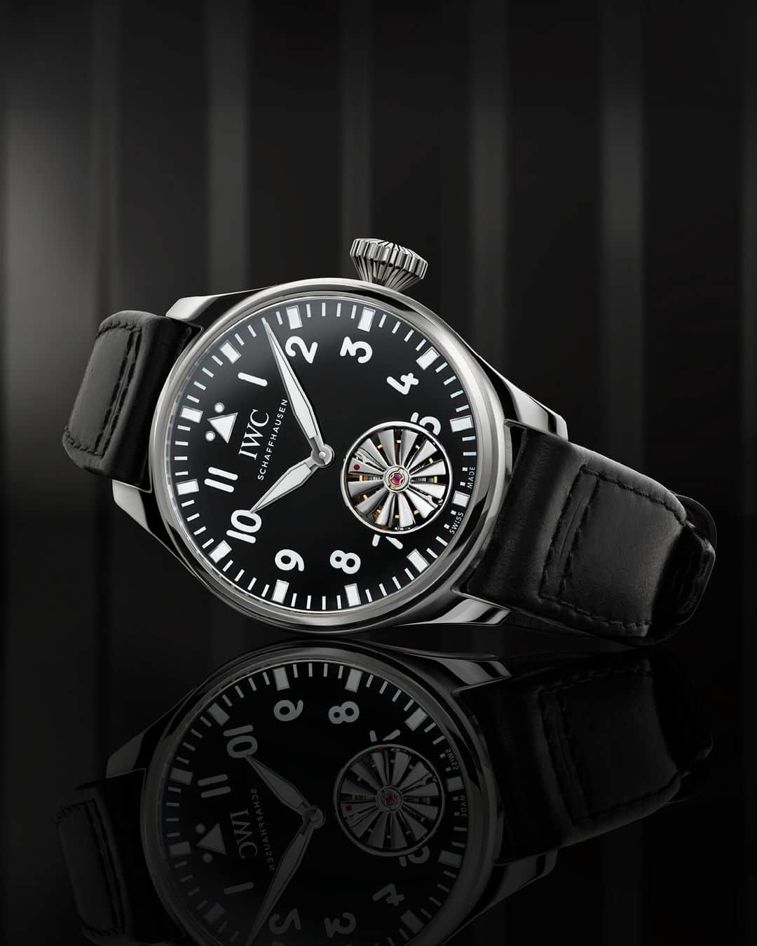 IWCのインスタグラム：「Flying high.  Introducing the Big Pilot’s Watch 43 Tourbillon Markus Bühler. Limited to 51 pieces, the watch’s signature aircraft turbine is integrated into a flying minute tourbillon at 6 o’clock, a feat for design and manufacturing. With its polished platinum case and crown, a glossy black dial and a black Cordovan leather strap featuring Bühler’s signature inside, it’s impressive on the wrist and a true collector’s edition.  🔗Link in Bio to discover more  #IWCbigpilot | #IWCwatches」