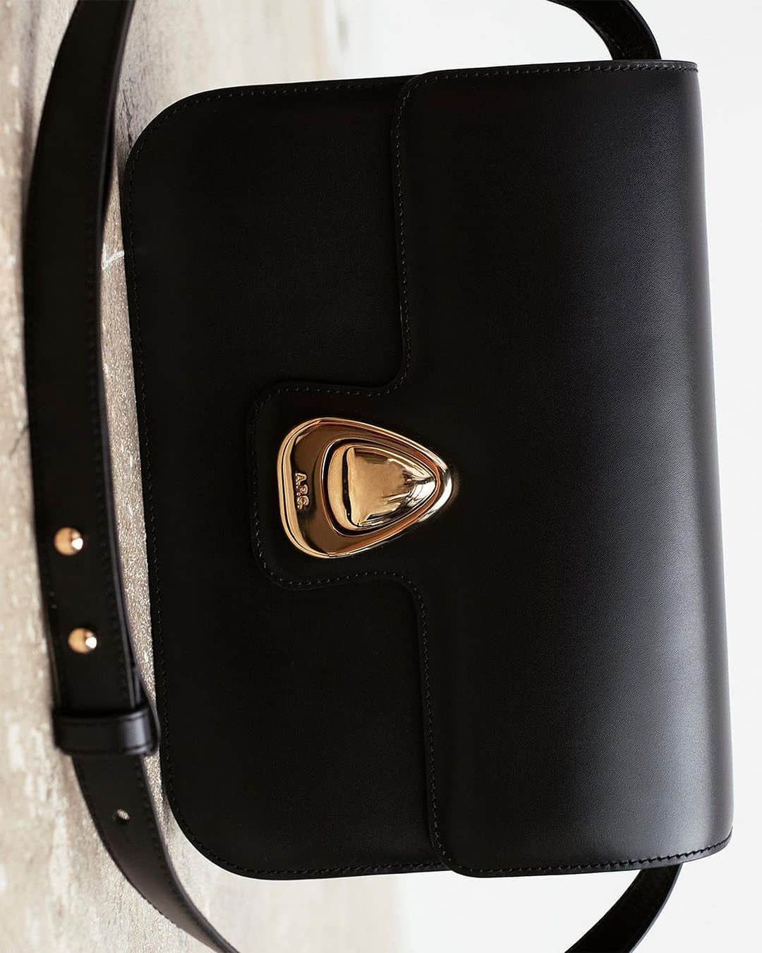 のインスタグラム：「The Astra bag is characterized by a unique drop-shaped clasp that adds a touch of feminine sophistication contrasting its clean box shape.   Photography by @angelechat  Art Direction by @fabricepaineau   #APCParis」