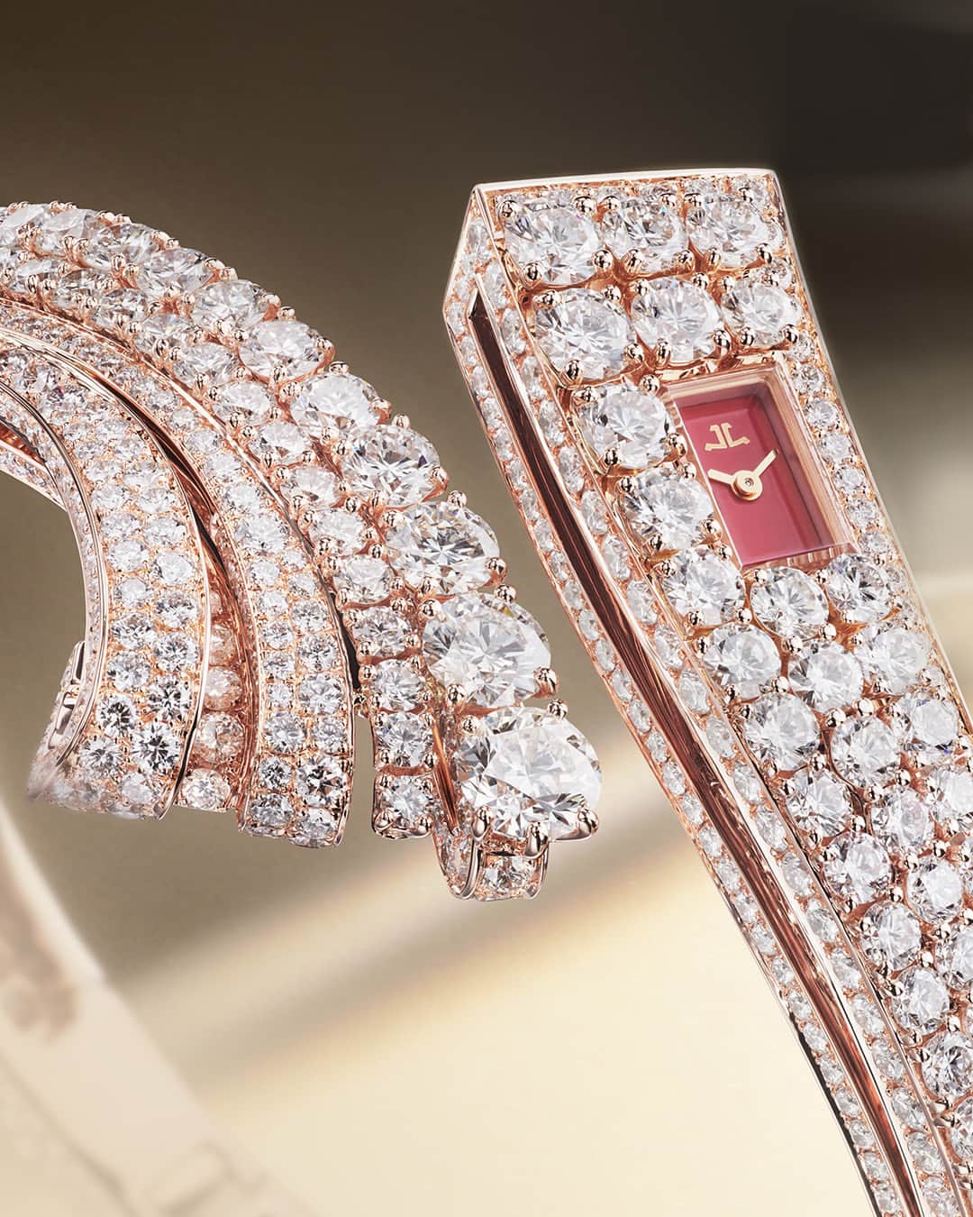 ジャガールクルトのインスタグラム：「A dress watch of exception. #Calibre101 _ 101 Bangle Designed, made and assembled in our Manufacture _ For the first time, Jaeger-LeCoultre introduces colours to the 101 Bangles with two new unique timepieces: one in pink gold with a red-orange lacquer dial and diamonds, and another one in white with sapphires and diamonds. Using the griffe- and the grain-setting techniques, these timepieces fully reveal the savoir-faire of our gem-setters. With its profiles also being covered in diamonds, the 101 Bangles showcase a play of light on the gemstones at every instant. _ #JaegerLeCoultre #Calibre101」