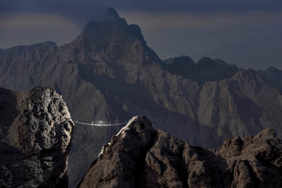 National Geographic Travelさんのインスタグラム写真 - (National Geographic TravelInstagram)「Photo by Robbie Shone @shonephoto | As the last daylight leaves us, the 90-foot-long (27 meter) suspension bridge of the Ivano Dibona via ferrata is silhouetted against a moody Dolomites sky. Being high in these mountains, perched above a deep gorge on an old and rusty bridge, is nothing short of spooky. However, our feelings of being unnerved are nothing next to the emotions felt by the soldiers who moved through this area a hundred years ago. When traveling here late in the day, we risk passing a cold night in the mountains without a sleeping bag—trivial compared with what they must have faced.  @natgeointhefield」9月11日 1時30分 - natgeotravel