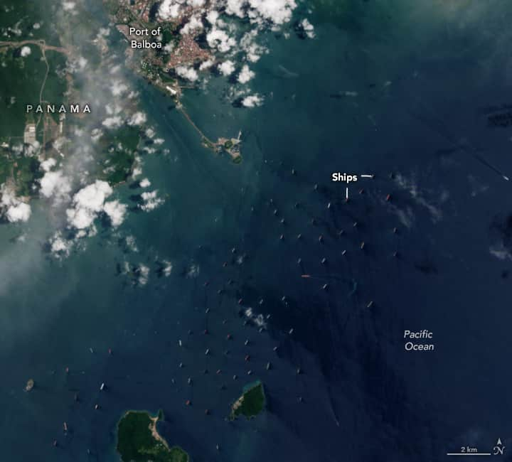 NASAさんのインスタグラム写真 - (NASAInstagram)「This #Landsat image shows ships delayed on the Pacific side of the Panama Canal on Aug. 18, 2023. Low water levels and ongoing drought caused a back-up in the canal, where up to 14,000 ships per year cross between the Atlantic and Pacific.  Image description:  Satellite image of ships waiting to cross the Panama Canal on August 18, 2023. Blue water of the Pacific Ocean covers most of the image. The water is dotted with many ships, which appear as brightly colored rectangles in the otherwise blue ocean. In the top left corner is the green and brown land mass of Panama, partially obscured by puffy white clouds. The canal is a straight line of water running through the country, passing the red and tan buildings of the Port of Balboa.」9月12日 0時30分 - nasagoddard