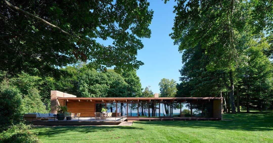 ELLE DECORのインスタグラム：「We’re careful when it comes to throwing around superlatives, but this three-bedroom lakeside retreat—first built in 1956— just might be the most swoon-worthy midcentury house we’ve ever published. Case in point: wood paneling, floor-to-ceiling glass, a primary bath shower sheathed in a mottled pink quartzite slab, sculptural furnishings, and unexpected alpaca textiles. “I had the flexibility to go with my gut and make mistakes,” the house’s owner and designer Celeste Robbins (@robbinsarchitecture) tells ELLE DECOR. “It wasn’t perfectly designed, but that organic evolution led to a home full of soul.”   Click the link in our bio to see inside this midcentury gem. Written by @alyssawbird. Photographed by @rogerdaviesphotography.」