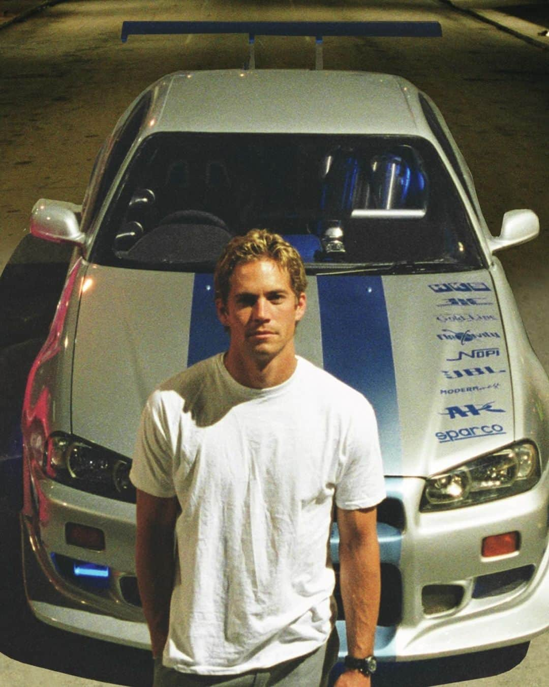 ポール・ウォーカーのインスタグラム：「Join us as we celebrate what would have been Paul’s 50th birthday. 💙  Paul’s legacy lives on strong through the @PaulWalkerFdn, his spirit guiding the mission to Do Good.™  For the first time ever, celebrate by pre-ordering this exclusive birthday tee and help us honor Paul’s memory, as 100% of profits fuel #ThePaulWalkerFoundation. Link in bio.  #DoGood #TeamPW  📷: Courtesy of Universal」