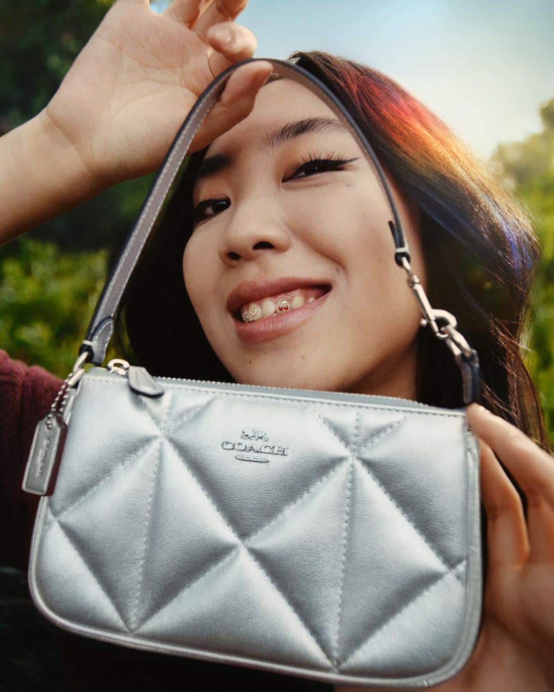 コーチのインスタグラム：「This Nolita 19 is making rapper #YoungjiLee beam. (Beam us up any day.) 🛸 Shop the entire Coach Shine Collection at the link in bio.   #WearYourShine. Our Fall 2023 story is a call to resist your inner critic and show your most confident self.  Photographer: @joshuawoods Stylist: @gabriellak_j Production design: Christian Stone Hair: @owengould Makeup: @hollysilius Nails:  @ronnajones  #CourageToBeReal #CoachOutlet」