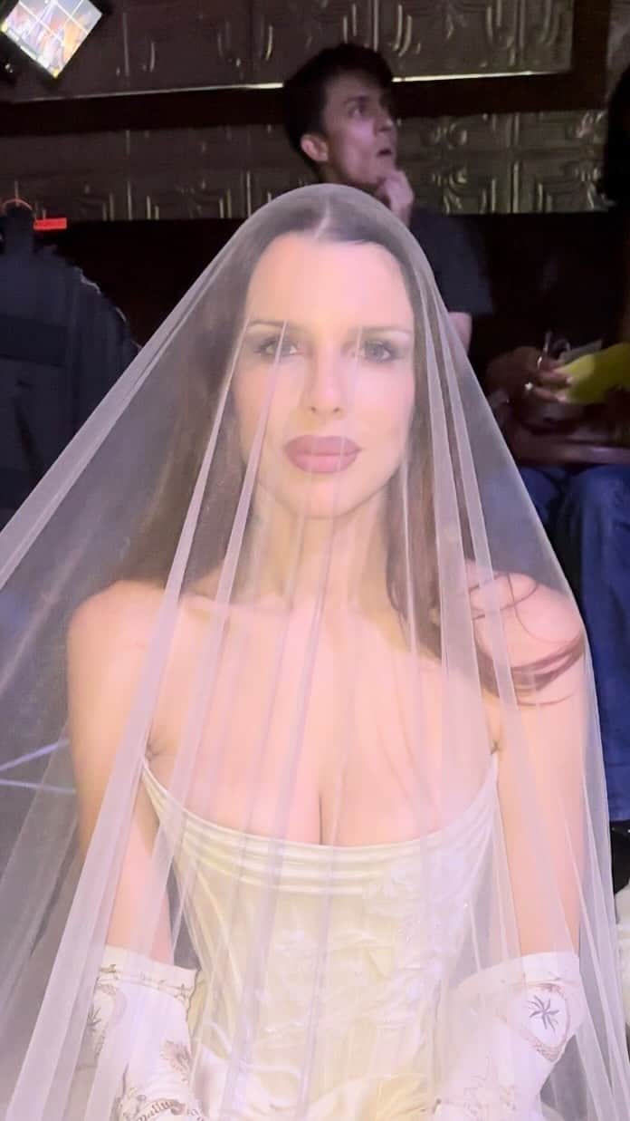 Nylon Magazineのインスタグラム：「#JuliaFox welcomes us to #Wiederhoeft‘s Spring/Summer 2024 show, wearing the designer’s latest bridal collection.   Themed “Night Terror at the Opera,” the S/S ‘24 runway gave guests a truly theatrical #NYFW experience at The Ellen Stewart Theatre — with models adorned in beaded corsets, signature Wiederhoeft silhouettes, and (wait for it) bedazzled “SECURITY” tank tops.   🎥 @kellychristinereed for NYLON」