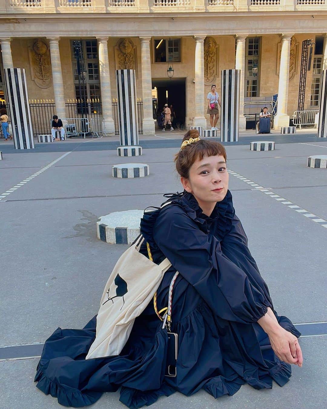 山野ゆりのインスタグラム：「コラボワンピ👗  @dacomecca  @carolina_glaser  @beams_official   詳細はプロフィール欄から覗いてみてね👀  生地をたっぷり使ってるので、座った時のシルエットらぶ🥹🩵🩵🩵 （是非座って欲しいです！  割烹着をイメージしたので上からばさっとかぶれます。素材がツルツルしてるので、パンくずをパッパッ🖐️はらいやすくなってます😍☜ポイント  ボリューミーでロマンティックなデザインですが、黒は誰でも着やすいと思います。 ピンクもあるんですが、とことんラブリー好みな方に是非着て欲しいです✨✨✨  個人的にラフに着るのが好みなので、写真はエコバック＋スニーカーでコーディネート。カチッとしたい時はオールバックでカチューシャ＋よそ行きバックとか🩵  そして、パリから帰ってきちゃいました。  空港着いてすぐコンビニのカレーパンを食べたのだけど、日本の惣菜パンもやっぱり最高なんだよねえ😍😍」