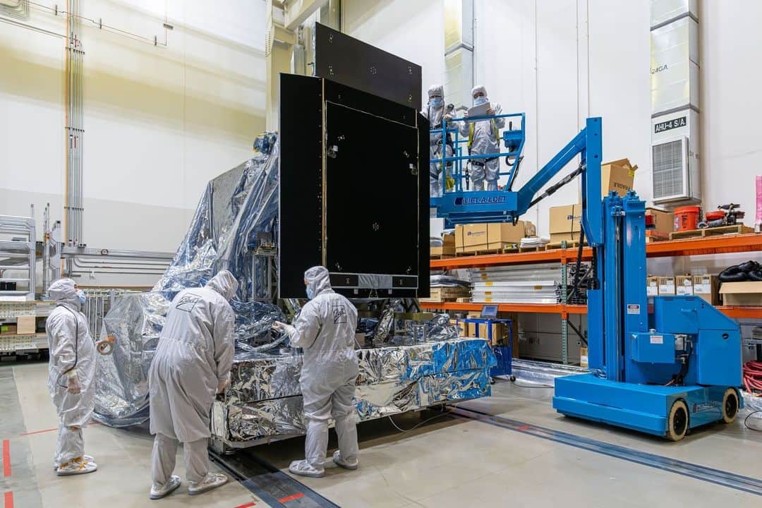 NASAさんのインスタグラム写真 - (NASAInstagram)「The instrument that will give us some of the largest images of the universe from space has just been completed and is ready for testing!   The Nancy Grace Roman Space Telescope's Wide Field Instrument (WFI) has finished construction at @BallAerospace and is now moving on to environmental testing, ensuring it can withstand the conditions of space and launch!   Check out the link in our bio to learn more about Roman's WFI!   Photo Credit: BallAerospace  Image description: 1: A wide shot of a silvery piece of space hardware about the size of a car sitting on a silver platform. Three techs in head-to-toe white suits are pushing the structure from behind through a very large, arched doorway that leads to a dark room lined with dim lights.   2:  Wide shot of the back of the Roman Wide Field Instrument, seen from this angle as a flat, black panel about as tall as a person and with rectangular flaps extending outward from each side and from the top, on a large silver platform. There are three people in head-to-toe white suits standing to the side of the structure. To the right, there are two people in head-to-toe white suits elevated on a blue crane and inspecting the top part of the instrument.  3: Wide shot, seven people in head-to-toe white suits pushing in a large structure covered in a plastic-looking drape.   4: Wide shot of the Roman Wide Field Instrument. It is a large round cylinder attached to a flat panel. The whole thing is covered in a gray tape-like material.」9月13日 23時21分 - nasagoddard