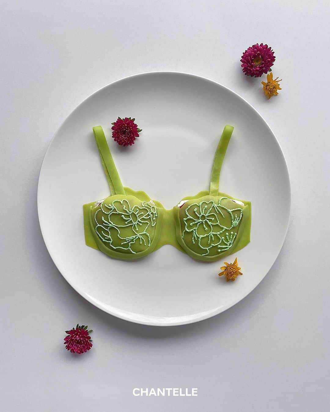 のインスタグラム：「“Lace and Petals" by @dimda_   We asked Daisuke the Japanese artist and culinary genius behind the @dimda_ account to reimagine a piece of our iconic "Fleurs" line.  Shown above : matcha crepe delight inspired by "Fleurs" half-cup balcony bra  #GoodEnoughToEat #Chantelle #ChantelleFleurs」