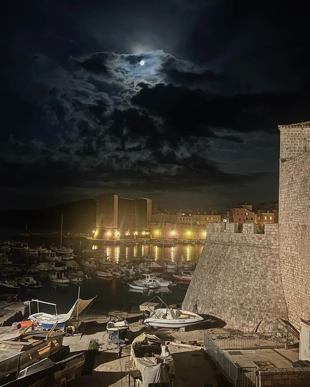 National Geographic Travelさんのインスタグラム写真 - (National Geographic TravelInstagram)「Photo by @nicholesobecki | During the day Dubrovnik’s Old Town surges with visitors, the hot sun baking its defensive stone walls. At night, though, another city emerges. A breeze drifts across the ancient port, carrying with it the distant notes of a Joseph Haydn cello concerto played by the Dubrovnik Symphony Orchestra. The moon winks at us through dark cloud cover.   To learn more about the remarkable world we share, follow along @nicholesobecki.」9月16日 3時30分 - natgeotravel