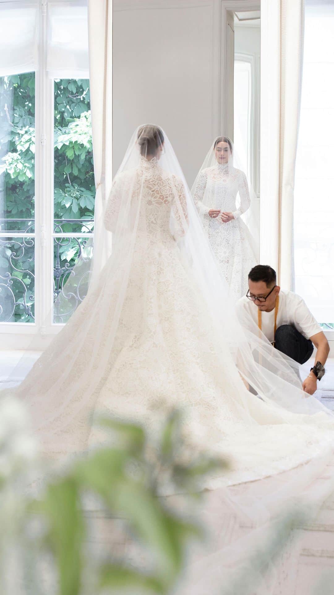キンバリー・アン・ウォーテマス・ティアムシリのインスタグラム：「Accompany the luminous bride, Thai ambassador @Kimmy_Kimberley, for her final fitting as she joyfully slips into her one-of-a-kind, couture wedding gown designed by @MariaGraziaChiuri. The finishing touches are orchestrated by a team of expert seamstresses in the Dior Ateliers, to ensure a flawless fit that gracefully embraces her silhouette. Every inch is adorned in a dreamy flourish of opulent floral guipure in soft shades of ivory and beige, culminating in a play of light and transparency. The reveal is a tribute to bridal dreams and a testament to the excellence of #DiorSavoirFaire. © Photo: Sophie Carre」