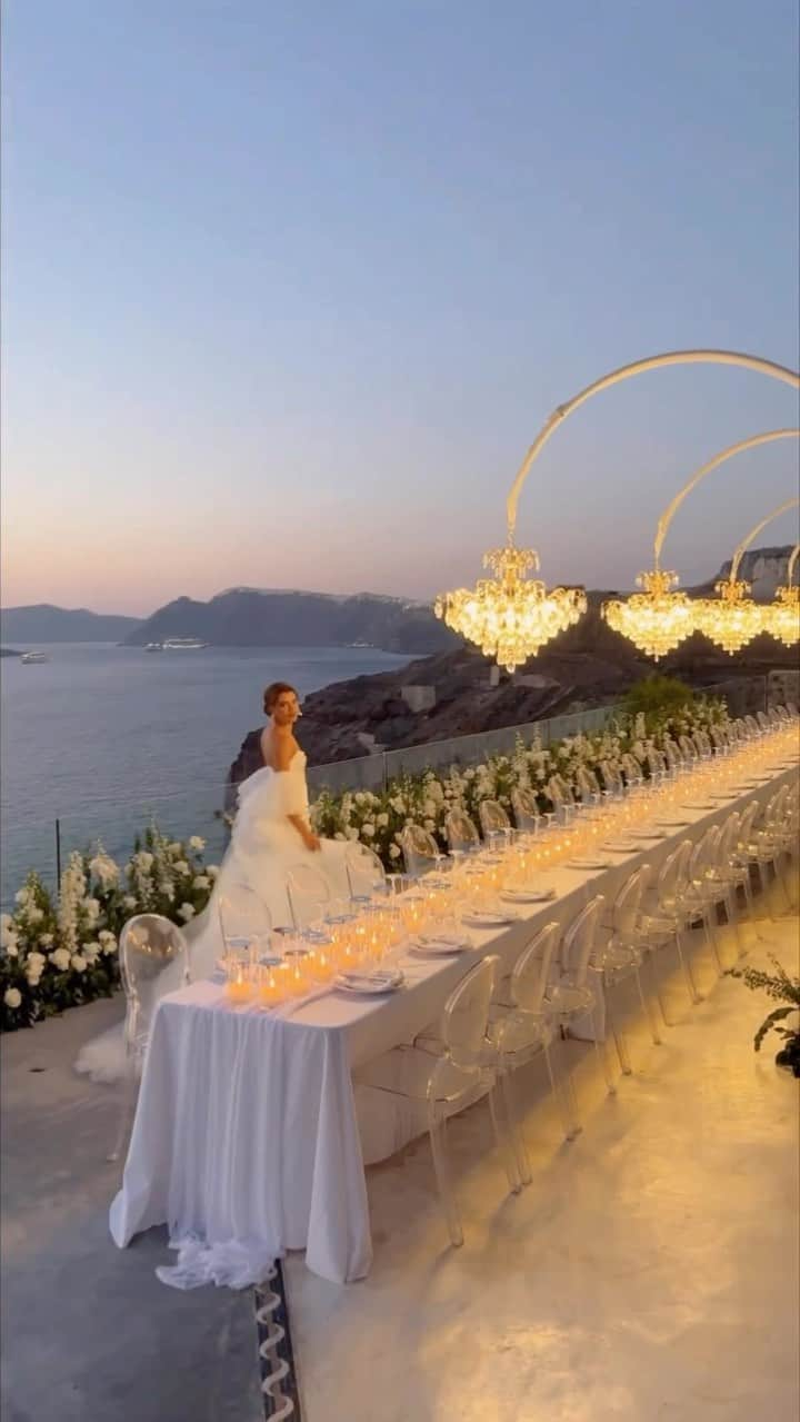 WEDDING APPARELのインスタグラム：「Big Fat Greece Weddings 💖 ✨ Save this for inspo & follow @Weddings for amore!  Planning & design: @tietheknotsantorini  Light & Sound: @santorinievents  Florist: @li_li_lab  Venue : @cavo_ventus_luxury_villa  Hair stylist : @bellahairstylist  Make up: @makeup.santorini.renia  Photography: @chrisandruth  Video: @madeinvideo  Catering: @mario_restaurant_catering  Candles: @idea.candles   #santoriniwedding #greecewedding #italywedding #spainwedding #portugalwedding #greeceweddingplanner #italyweddingplanner #weddingchandelier」