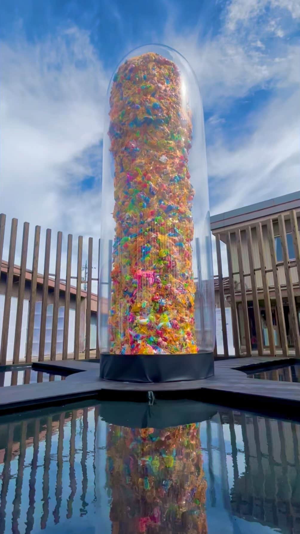 増田セバスチャンのインスタグラム：「Beneath our skin runs colorful blood – A colorful tower appears in the Nakajima lock area, where nature and man-made structures are in harmony. Countless unique colors confront each other in a space surrounded by trees and water in Toyama Prefecture, The myriad of unique colors confront each other in a space surrounded by trees and water in Toyama Prefecture, showing us how to jump over the barriers of race, religion, age, gender, national borders, and so on.  Sebastian Masuda [Polychromatic Skin -Gender Tower- #Hokuriku] H5,750mm × W1,585mm Mixed media  It is exhibited at this art festival ➡️ @goforkogei」