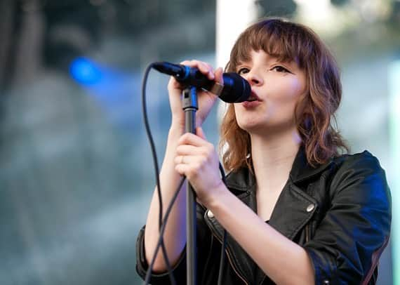 CHVRCHESのインスタグラム：「Right after playing The Mother We Share on this day in 2013, the rain began to pour on Virgin Mobile Freefest in Columbia, MD. Maybe that’s why there are so many lyrics about water in our catalogue…  📷 Brandon Wu」