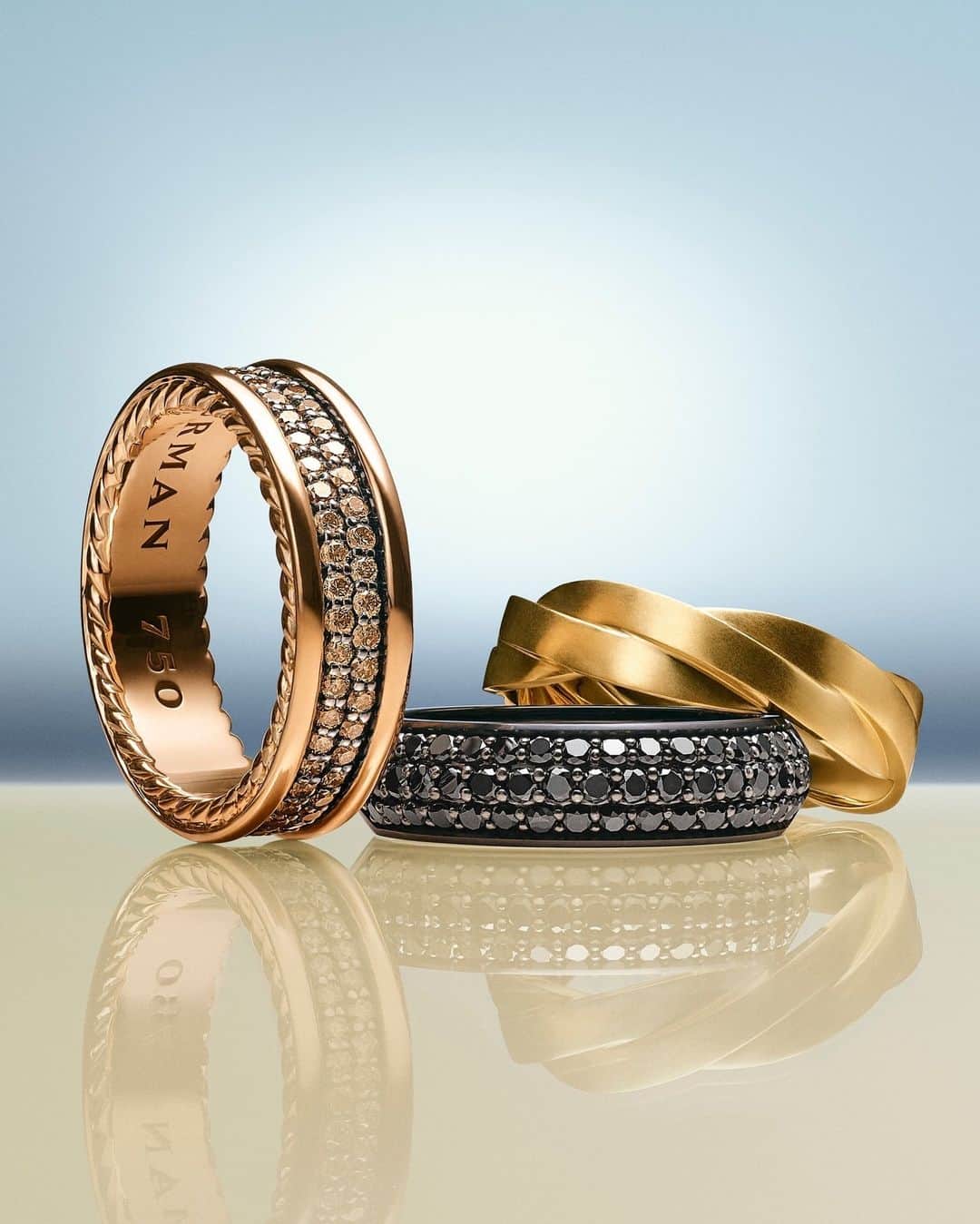 のインスタグラム：「Masculinity redefined by creativity. Streamline rings with cognac and black pavé diamonds play well with a classical DY Helios yellow gold band ring.   #DavidYurman #DYHelios #DyStreamline」