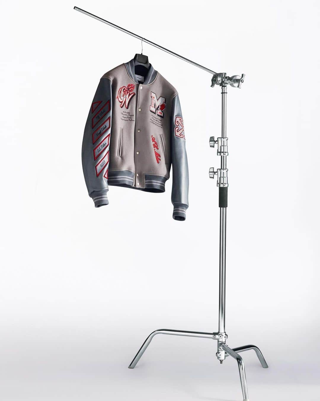 OFF-WHITE C/O VIRGIL ABLOHのインスタグラム：「Off-White™ c/o AC Milan  the capsule revolves around a gray Varsity jacket with graphic patches, including the Off-White™ diagonal on the right sleeve and the AC Milan “diavolo” mascot on the back. the same design is worn by @acmilan players as part of their Uniforms.  the Off-White™ c/o AC Milan capsule collection is now exclusively available at Off-White™ Milan boutique and online at off---white.com, @farfetch.」