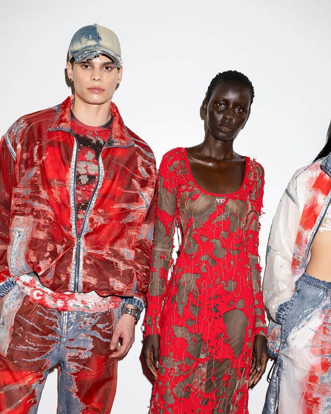 ディーゼルのインスタグラム：「Seeing red.    Creative Director @glennmartens’ collection for the #DieselSS24 Runway Show is a masterful expression of Diesel codes. Bold and agile, he mixes Diesel red, denim and the Oval D logo with couture techniques for exquisitely distressed looks that emanate desire and freedom.   Devoré denim is reverse printed with the Diesel red logo. Burn out denim dresses and shredded indigo jacquard knits look like artful tatters. New denim boots have an Oval D embedded in the toe.    Discover the full collection at the link in bio.   #ForSuccessfulLiving」