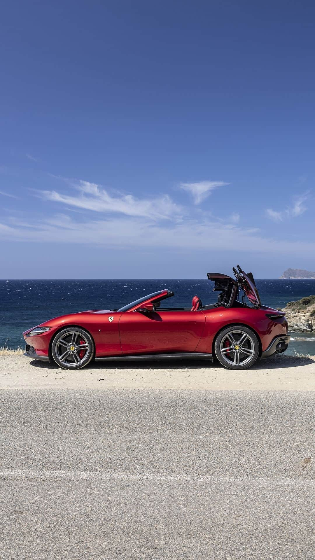 フェラーリのインスタグラム：「Top down, all set to roll. Get ready to embrace the sea breeze in the #FerrariRomaSpider.  #LaNuovaDolceVita #CapoSpartivento #Sardinia #Ferrari」