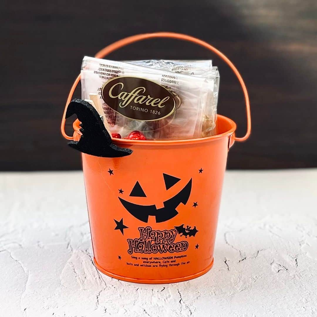 カファレルチョコレートのインスタグラム：「新登場🎃ハロウィンバケット  ジャックオランタンのバケツにチョコレートがたっぷり入ったセットが登場！ ブリキ製のバケツには魔女の帽子のクリップ付き。 バケツいっぱいのチョコレートでハロウィンをおたのしみください♪  バケツとのセットが気になる方は「🎃」の絵文字で教えてくださいね ハロウィンパッケージのアイテムは季節限定！お買い逃しなく  【販売店舗】 神戸北野本店 神戸居留地 グランスタ東京 オンラインショップ  【概要】 チョコレート50粒 ・ジャンドゥーヤ ・キャット ・ミニハート ・きのこ ・ユーロコイン  店頭価格:2,700円（税込） オンライン:3,690円（税込）  ー・ー・ー・ー・ー・ー・ー・ー・ー・ー・ー・ー・ お写真に #カファレル のハッシュタグをつけて投稿すると 当アカウントで紹介させて頂く場合がございます🍫 ー・ー・ー・ー・ー・ー・ー・ー・ー・ー・ー・ー・  #カファレル #ジャンドゥーヤ #caffarel #かわいいチョコレート #ハロウィン」