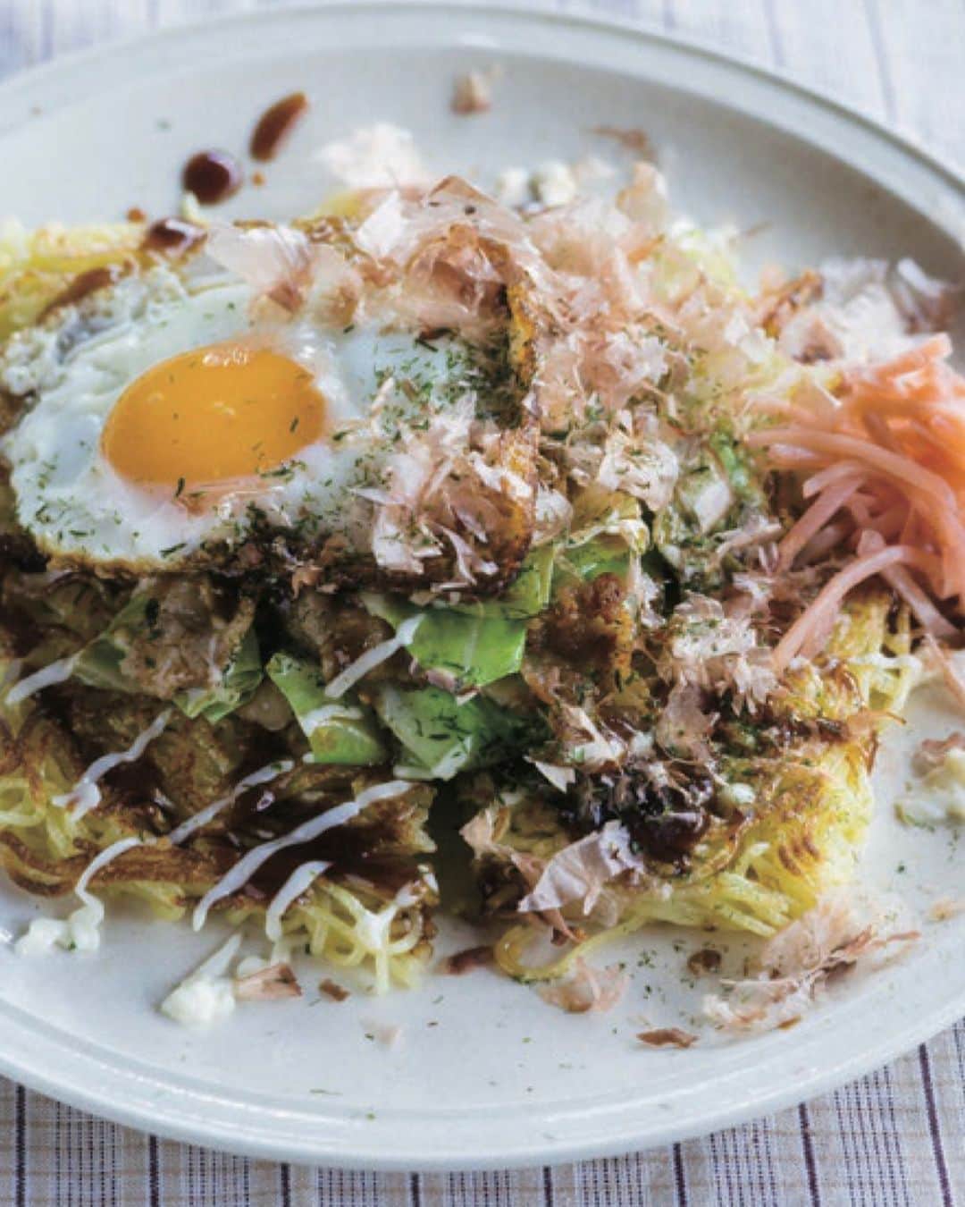 小堀紀代美のインスタグラム：「お好み焼き？モダン焼き？に見えたりするこれは、麺を焼き付けて具をのせていきます。　炒め合わせたら焼きそばだけど、盛り付けの工夫で作るのも見た目も楽しくなったりします。  デザートは好きな大きさに取り分けたり、スプーンですくったり、食後に食べたい分だけ分け合ったり。  今月発売となった２冊『ごはんのように食べる麺』『ライクライクキッチンの食後のデザート』どうぞよろしくお願いします。」