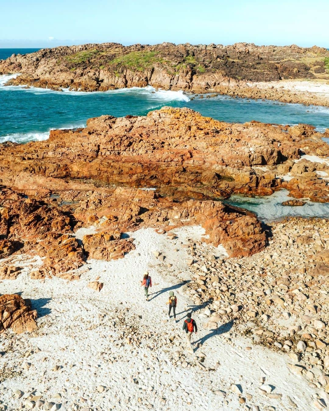 Australiaさんのインスタグラム写真 - (AustraliaInstagram)「Lace-up those hiking boots, folks! 🥾 From summit views to sand dunes, the brand-new Tomaree Coastal Walk is a 2-3 day trek through Worimi Country. Kicking off at #TomareeHead in @visitnsw's #ShoalBay, walkers will be treated to dazzling ocean vistas, sparkling beaches, unique rock formations and an abundance of flora and fauna, before wrapping their journey at the majestic sand dunes of Worimi Conservation Lands in @visitportstephens - the largest moving dune system in the southern hemisphere!🌿👣   #SeeAustralia #ComeAndSayGday #FeelNSW @nswnationalparks   ID:  1. Three people walk on white sand towards turqiose water along an orange rocky coastline. 2. Three people walk along a trail through thick green vegetation. To the left, is a small rocky beach.  3. Three people stand on a coastal lookout. Mountains and sandy beaches dot the coastline behind them.  4. Three people walk through a dense rainforest. Sun filters in through the leafy green trees.」9月29日 5時00分 - australia