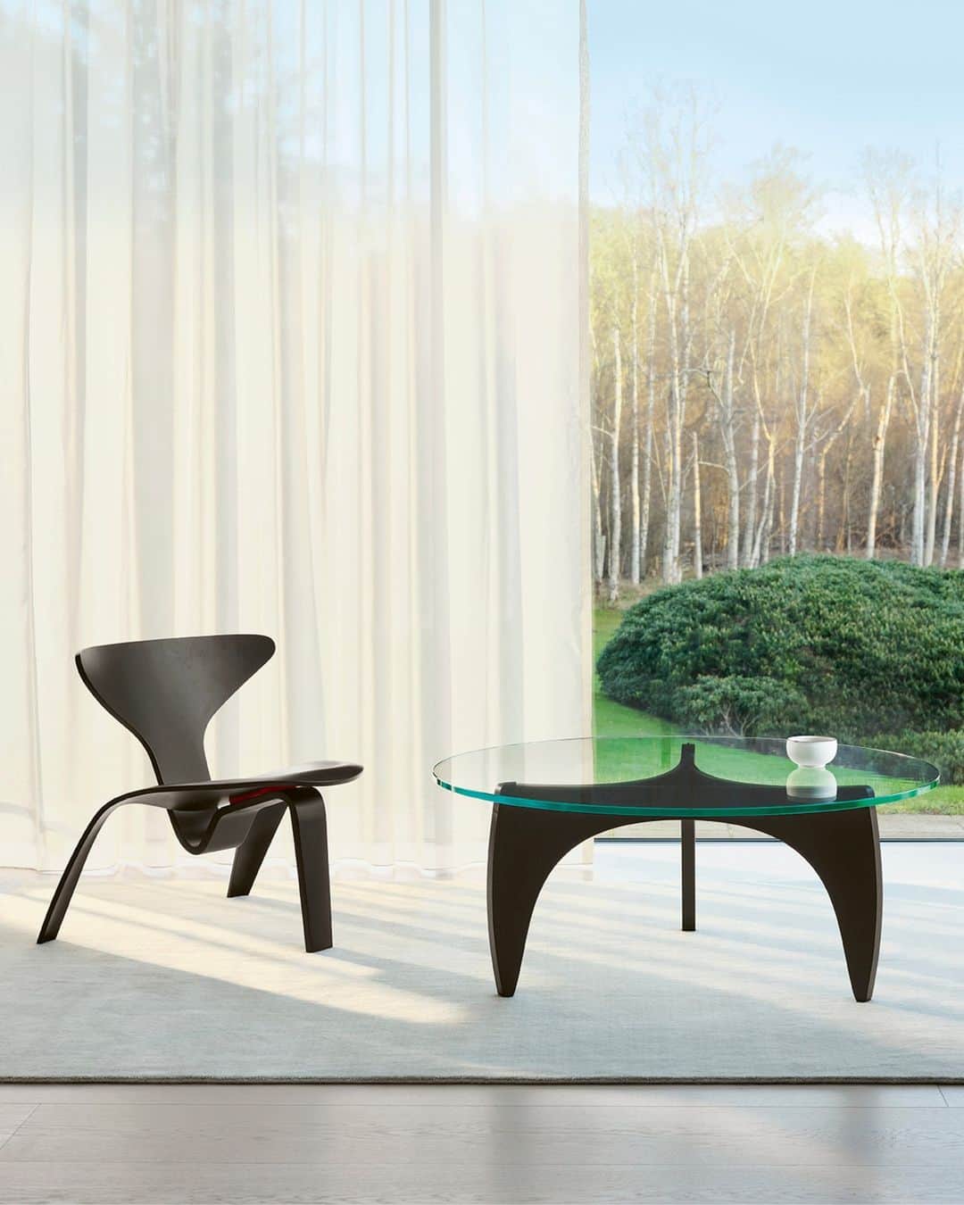 のインスタグラム：「The PK60™ coffee table and PK0 A™ chair: Two works of art that combine aesthetics and function. ⁠ ⁠ Poul Kjærholm designed both pieces in 1952. ⁠ ⁠ The PK60 table's glass top reveals the sculptural shapes of the interlocking pieces of veneer wood.⁠ ⁠ With both pieces, the extraordinary interlocking shapes of the chair and table base play at the outer limits of steam bending technique possibilities, shaping forms into a united whole. ⁠ ⁠ What do you think of these designs? Share your thoughts in the comments. ⁠ ⁠ Explore the pieces up close via the link in bio. ⁠ ⁠」