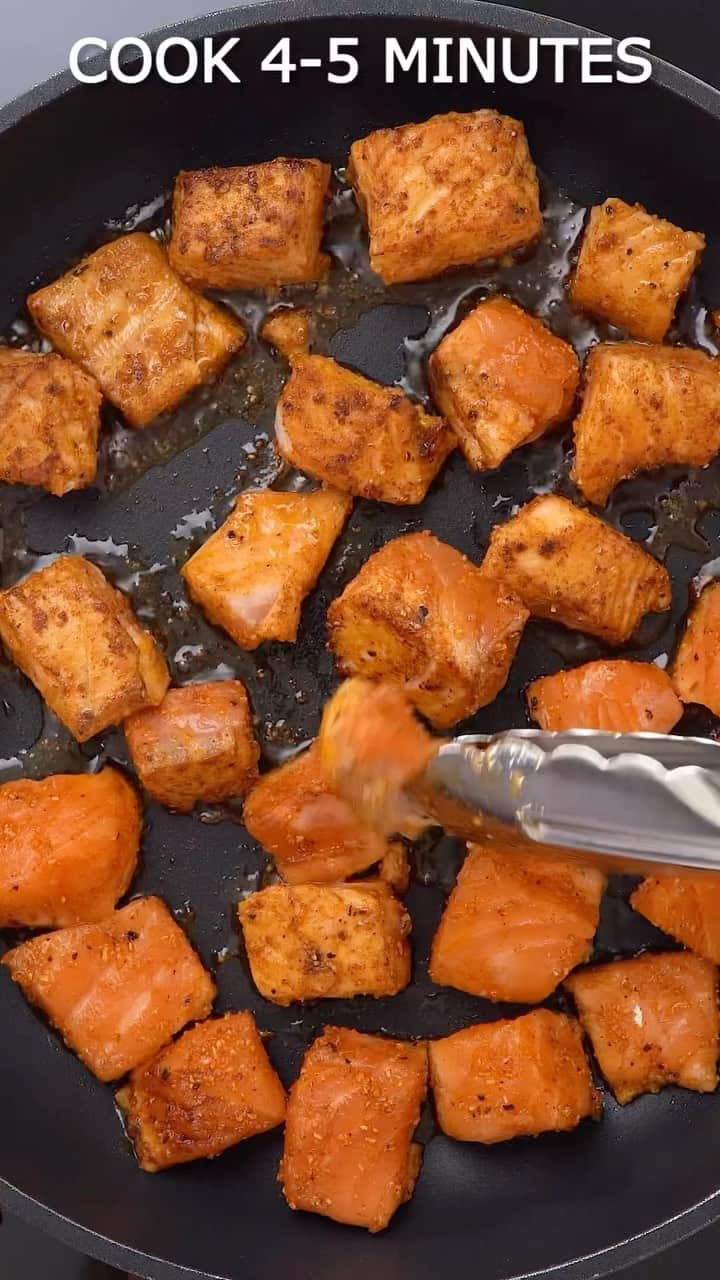 Easy Recipesのインスタグラム：「This quick honey glazed salmon is a light meal that only takes minutes to make.  It’s the perfect recipe to have on hand for busy nights and may be the easiest salmon recipe you’ve ever made.  Ingredients ▢ 1 ½ lb salmon skin removed and cut into 1-inch cubes ▢ 1 teaspoon paprika ▢ 1 teaspoon garlic powder ▢ 1 teaspoon onion powder ▢ ¾ teaspoon salt ▢ 1 teaspoon ground black pepper ▢ 3 tablespoons olive oil divided ▢ 2 teaspoons garlic minced ▢ 1 teaspoon ginger grated ▢ 3 tablespoons soy sauce ▢ 2 tablespoons rice vinegar ▢ ¼ cup honey ▢ 2 teaspoons sesame seeds ▢ 2 teaspoons chopped chives  Instructions Pat dry the salmon cubes with a paper towel and season them with paprika, garlic powder, onion powder, salt, and black pepper. Pour about a tablespoon of oil and massage the salmon cubes. Heat a heavy skillet with a tablespoon of oil, add the salmon cubes in a single layer, and cook for 4-5 minutes by flipping them often until crispy and golden. Transfer the cooked crispy salmon cubes to a plate and cook the remaining salmon. To the same skillet add the remaining oil and add garlic and ginger, saute for a minute. Stir in the soy sauce, rice vinegar, and honey. Simmer the sauce for 3-5 minutes until it thickens. Transfer the crispy salmon back to the skillet and toss it well with the sauce. Check for seasonings. Serve the salmon bites over the rice and enjoy.」