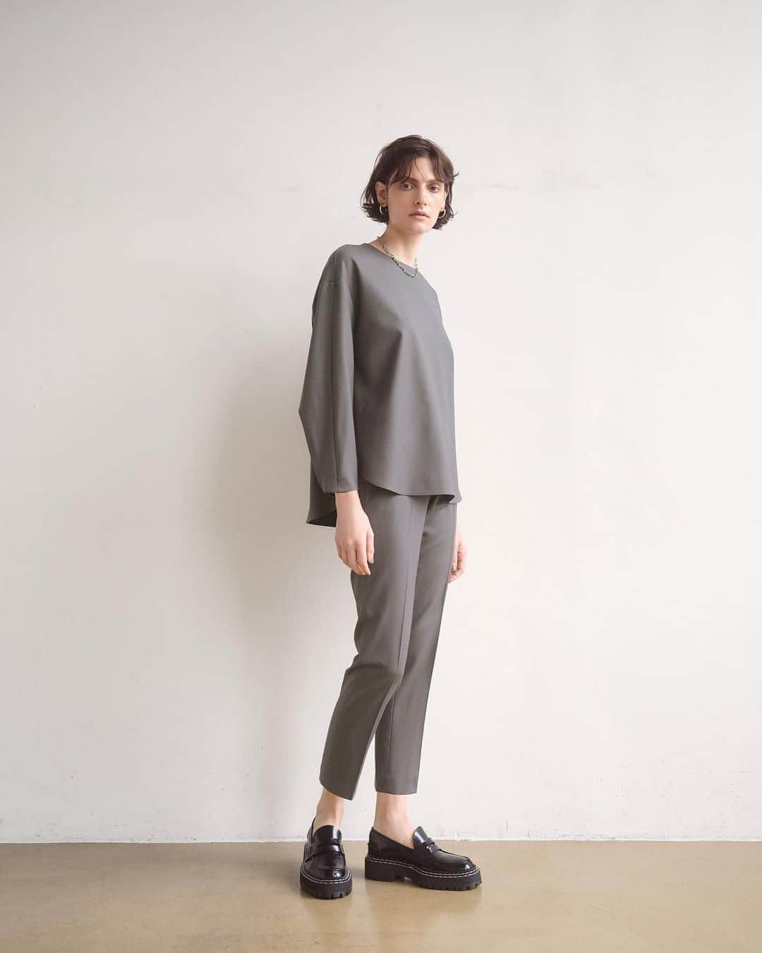 Theory luxe official account.のインスタグラム：「［COZY ELEGANCE］  同素材のブラウスを合わせたセットアップでほんのりモードに  ノーブルに印象付ける、さりげなく温度感のあるグレーが新鮮。 同素材のブラウスを合わせれば、瞬時に着映えのするセットアップスタイルに。  ブラウスもパンツも余計な装飾を削ぎ落としたクリーンなデザインなので、選ぶ小物次第でエレガントにもマニッシュにもアレンジが楽しめる。 シルバーアクセサリーと厚底ソールのローファーで、モード感をプラスして。  #theoryluxe #セオリーリュクス  #セットアップ #パンツスタイル #ワントーンコーデ」