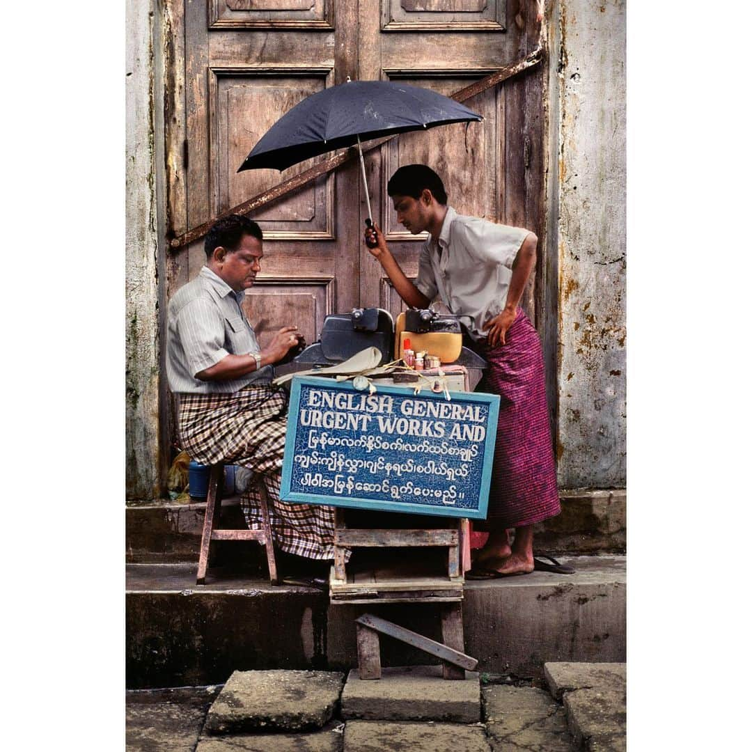 スティーブ・マカリーのインスタグラム：「Sidewalk scribe during the monsoon. Rangoon, Burma, 1994.」