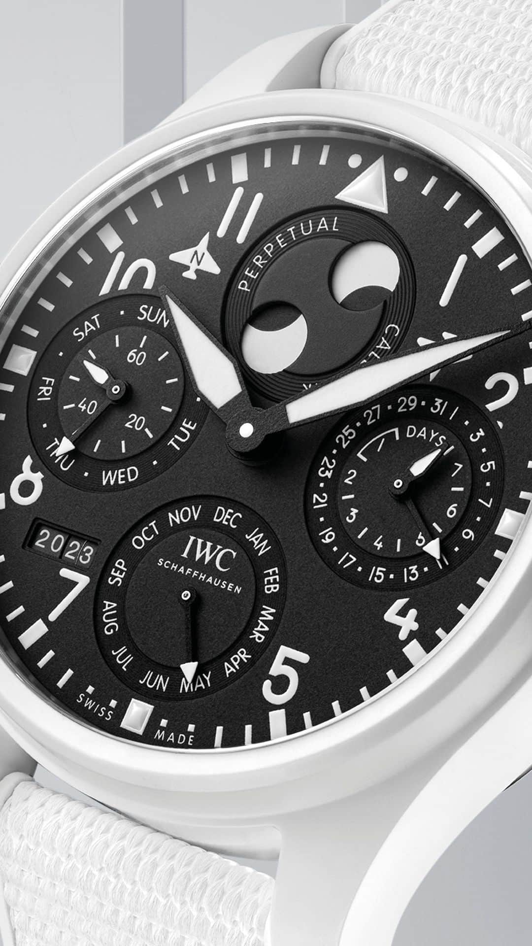 IWCのインスタグラム：「Developed by Kurt Klaus in the 1980s the perpetual calendar module is mechanically programmed to recognize the different month lengths and the leap years. The patented double moon phase display shows the moon as seen from the northern and southern hemispheres and thanks to a special reductionist gear train, it is so precise that it will only deviate by one day after 577.5 years. The calendar module is driven via a single nightly switching impulse by the IWC-manufactured 52615 caliber movement with a power reserve of 7 days.   #IWCpilot | #IWCtopgun | #IWClaketahoe  🔗Link in bio  ℹ Black dial Ceramic case, 46.5mm IWC-manufactured 52615 Calibre See-through sapphire glass back Ref. IW503008」