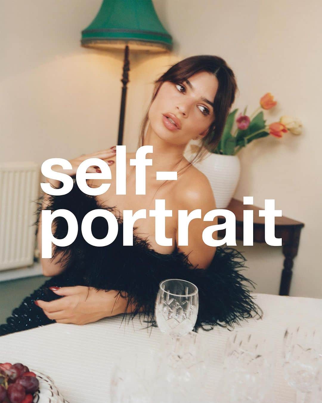 SELF PORTRAITのインスタグラム：「AT HOME, WITH SELF-PORTRAIT  Emily @emrata wears a black rhinestone embellished midi dress with feather trim」