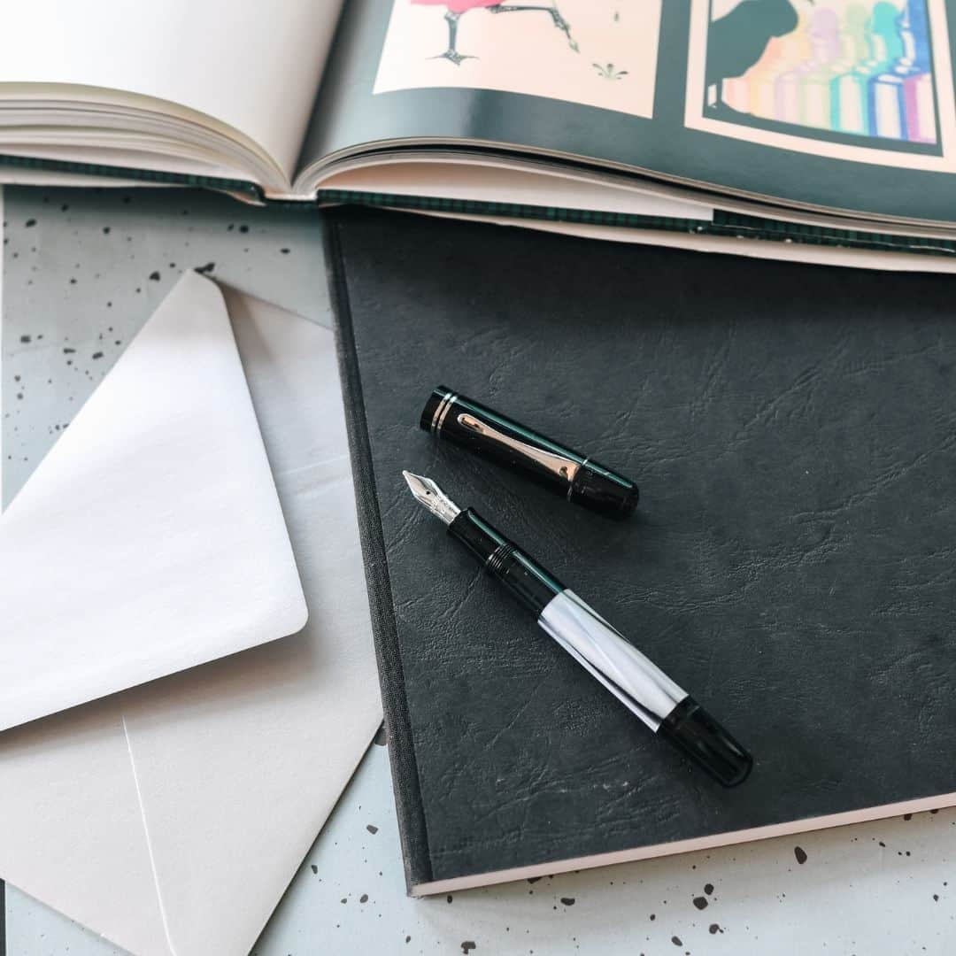 ペリカンのインスタグラム：「Embracing the beauty of bygone eras, the Pelikan Special Edition M101N Grey-Blue brings a touch of history to modern elegance. Crafted with meticulous precision and adorned with exquisite materials, this fountain pen is a timeless work of art. Try yourself and feel it!  The details: high-quality cellulose acetate in grey-blue swirls self-polishing deep black resin palladium-plated clip decorative rings fully rhodium-plated 14-karat gold nib for very smooth writing  #PelikanPassion #M101NGreyBlue」