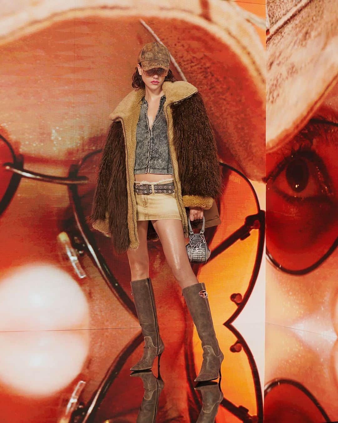 ディーゼルのインスタグラム：「Earth angel.   From the #DieselFW23 collection, Earth Shades with a raw attitude. A shaggy faux fur shearling jacket, a denim top and micro mini skirt finished with raw edges are anchored with stiletto Oval D boots.    Tap to shop and discover more at the link in bio.   #ForSuccessfulLiving」