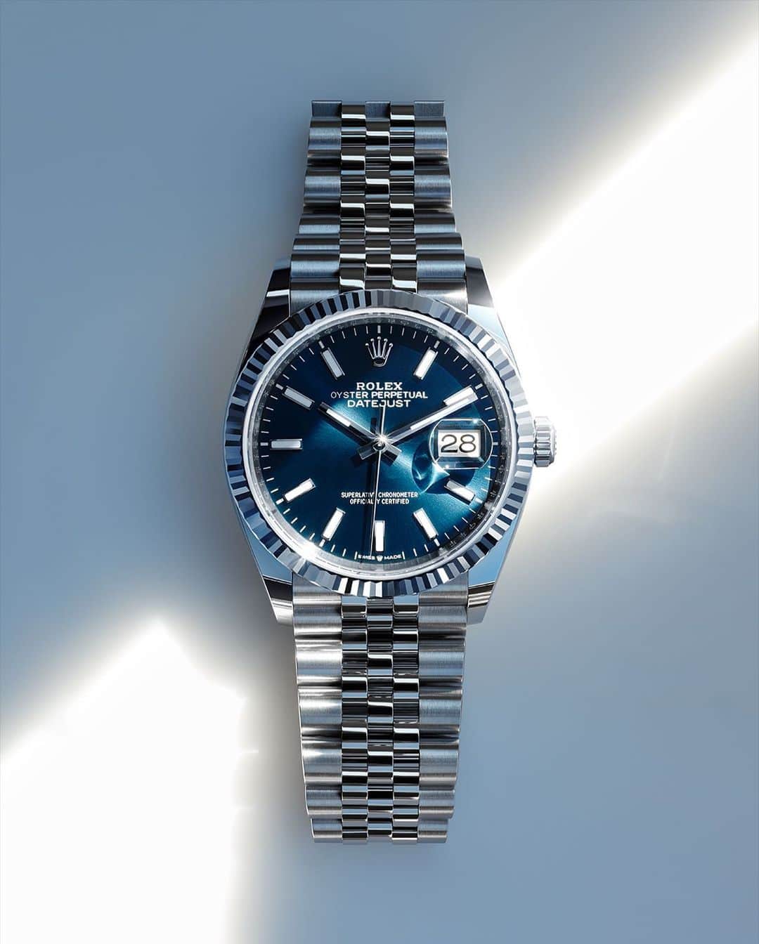 rolexのインスタグラム：「Timeless comfort. The Datejust 36 in Oystersteel and white gold, with a bright blue dial and Jubilee bracelet, offers optimal legibility of the date thanks to its Cyclops lens. This emblematic Rolex feature, introduced in 1953, bears witness to life’s most precious moments. #Rolex #Datejust #101031」