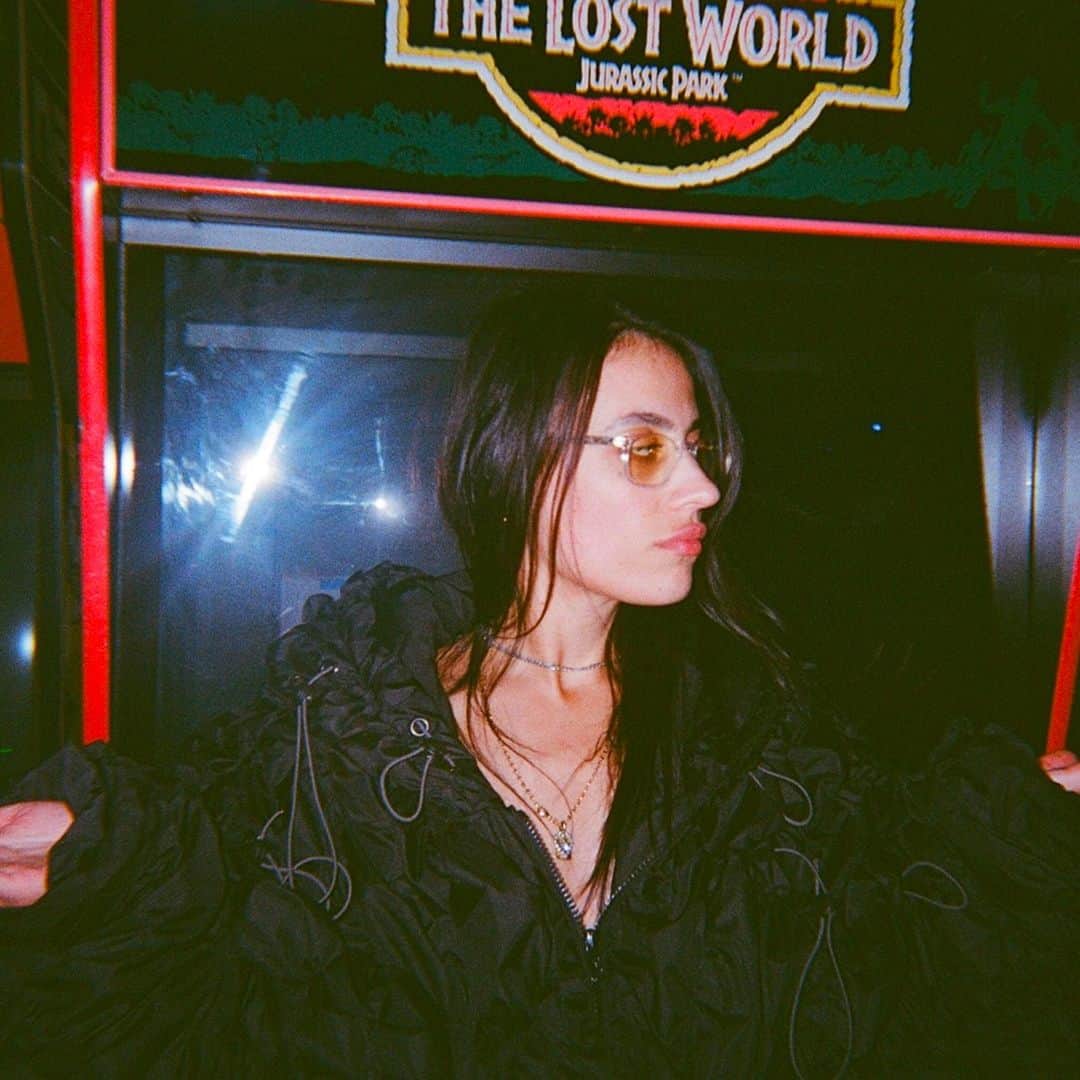 Dazed Magazineさんのインスタグラム写真 - (Dazed MagazineInstagram)「@COUCOUCHLOE arrives at @NQ64arcadebars in Shoreditch and almost immediately spills a drink over herself 👾⁠ ⁠ Although her ultra-gorpcore @anaselivanova jacket is collateral damage, she styles it out – her skin and hair glisten with a glass’s worth of booze and she adds a slick of lipgloss to finish the wet look. The bar we’re in is dark and neon-lit with flashing retro consoles and a very loud Chief Keef soundtrack.⁠ ⁠ The @nuxxe_ collective member has just released mixtape Fever Dream, a collection that is “two years of friends and life and everything”, she says. It draws together an impressive crop of collaborators including @eartheater 645ar @louisbrodinski @iamrealnene and mop-haired teen rapper @mattox⁠ ⁠ The cover art is a sketched caricature of COUCOU CHLOE, with an exaggeratedly large forehead, droopy-lidded eyes and a plumped-up, dissociative pout. “I liked the idea of a caricature, or a grotesque, as a way to let go... It was really interesting to see the perspective of someone who doesn’t know me at all. It's like, ‘What do you see?’”⁠ ⁠ Read the full interview through the link in our bio 🔗⁠ ⁠ ✍️ @felicitaaaay⁠ 📷 @hattirex⁠」10月7日 1時02分 - dazed