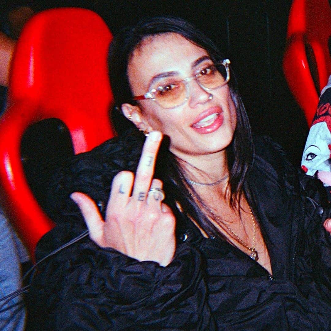 Dazed Magazineのインスタグラム：「@COUCOUCHLOE arrives at @NQ64arcadebars in Shoreditch and almost immediately spills a drink over herself 👾⁠ ⁠ Although her ultra-gorpcore @anaselivanova jacket is collateral damage, she styles it out – her skin and hair glisten with a glass’s worth of booze and she adds a slick of lipgloss to finish the wet look. The bar we’re in is dark and neon-lit with flashing retro consoles and a very loud Chief Keef soundtrack.⁠ ⁠ The @nuxxe_ collective member has just released mixtape Fever Dream, a collection that is “two years of friends and life and everything”, she says. It draws together an impressive crop of collaborators including @eartheater 645ar @louisbrodinski @iamrealnene and mop-haired teen rapper @mattox⁠ ⁠ The cover art is a sketched caricature of COUCOU CHLOE, with an exaggeratedly large forehead, droopy-lidded eyes and a plumped-up, dissociative pout. “I liked the idea of a caricature, or a grotesque, as a way to let go... It was really interesting to see the perspective of someone who doesn’t know me at all. It's like, ‘What do you see?’”⁠ ⁠ Read the full interview through the link in our bio 🔗⁠ ⁠ ✍️ @felicitaaaay⁠ 📷 @hattirex⁠」