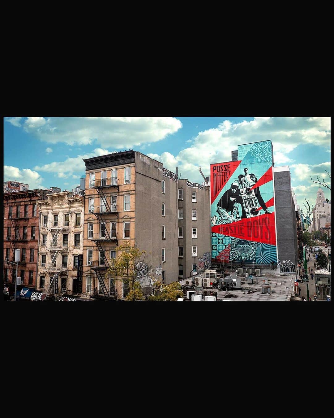 Shepard Faireyのインスタグラム：「The crew and I just completed an 8 story @beastieboys mural as part of the NYC Hip Hop 50 celebration at the corner of 14th and Ave. A. After my best childhood friend started at NYU in 1990, I began putting up street art in the Village on a regular basis so this location is significant for me. This is also an area where the Beastie Boys hung out and they recorded their first E.P. down the street at 171 A… where the Bad Brains also recorded their ROIR album. The mural is based on a Licensed to Ill era Beasties photo by @glenefriedman, who also shot their Check Your Head cover. When the Beastie Boys’ album Licensed to Ill came out, I was exhilarated by their metamorphosis into a hip-hop group from a punk band because I had mainly been listening to punk. Even though I liked RUN-DMC and the hip-hop from Beat Street and Breakin’, I felt awkward being into hip-hop as a white kid. Licensed to Ill was instantly infectious and a thrilling sonic encapsulation of bratty teen rebellion. It was (and is) a great hip-hop album. The Beasties blew the doors open for me to embrace other hip-hop and they kept evolving musically and spiritually while redefining what was possible within the genre. I’m forever grateful to the Beasties for their contribution to culture and the soundtrack of my life… and for their embrace of, and contribution to, this mural project!  The work on the mural was hot and grueling so thanks to my crew of Rob Zagula and Jon Furlong (who also shot the pics!) as well as Amanda, Oscar, and Sher who were local help from the @lisaprojectnyc crew. It takes long hours and intense physical effort to paint at this scale and I’m incredibly grateful for the hard work from everyone. This project also would not have happened without the intense efforts of Wayne and Rey from @lisaprojectnyc and the generous support of @hardrockhotelnyc.  –Shepard  Photos: @jonathanfurlong」