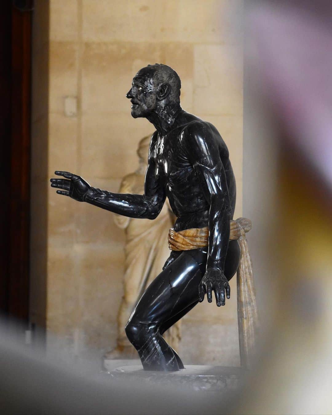 のインスタグラム：「#LouvreAnecdotes 🇫🇷 Savez-vous que l’un des chefs-d’œuvre de la Salle du Manège a été réalisé en marbre noir ?   - 🕰️ Découverte à Rome en 1594, sur l’Esquilin, cette sculpture marque les esprits par le regard du personnage, sa posture, et la noirceur de la pierre. Mentionnée dès 1599 dans la célèbre collection Altemps, elle est ensuite acquise par le cardinal Scipion Borghèse.   - ✍️ Dès son exhumation, l’œuvre est comprise comme une représentation de Sénèque, précepteur de l'empereur Néron contraint au suicide. Il s’agit en réalité plutôt d’une vision d’époque romaine d’un vieux pêcheur, conçue d’après un original perdu de l’époque hellénistique. -   👀 Elle fascine les artistes et notamment Rubens, qui s’en inspire en 1612 pour sa Mort de Sénèque (Alte Pinakothek, Munich). Achetée par Napoléon 1er auprès de Camille Borghèse en 1807, elle est déposée au musée du Louvre.  ∴ 🌎 Did you know that one of the masterpieces in the Salle du Manège was created in black marble?   - 🕰️ Discovered in Rome in 1594, on the Esquiline, this sculpture made a lasting impression, thanks to the figure's gaze, his posture and the blackness of the stone. Mentioned as early as 1599 in the famous Altemps collection, it was subsequently acquired by Cardinal Scipio Borghese.   - ✍️ As soon as it was exhumed, the work was understood to be a representation of Seneca, Emperor Nero's preceptor who was forced to commit suicide. In reality, it's more a representation of an old fisherman from the Roman period (2nd century), based on a lost Hellenistic original.   - 👀 It fascinated artists such as Rubens, who drew inspiration from it in 1612 for his Death of Seneca (Alte Pinakothek, Munich). Purchased by Napoleon 1st from Camille Borghese in 1807, it was deposited in the Musée du Louvre. - 📷 © Musée du Louvre / Nicolas Bousser  . . . #Louvre #MuséeDuLouvre」