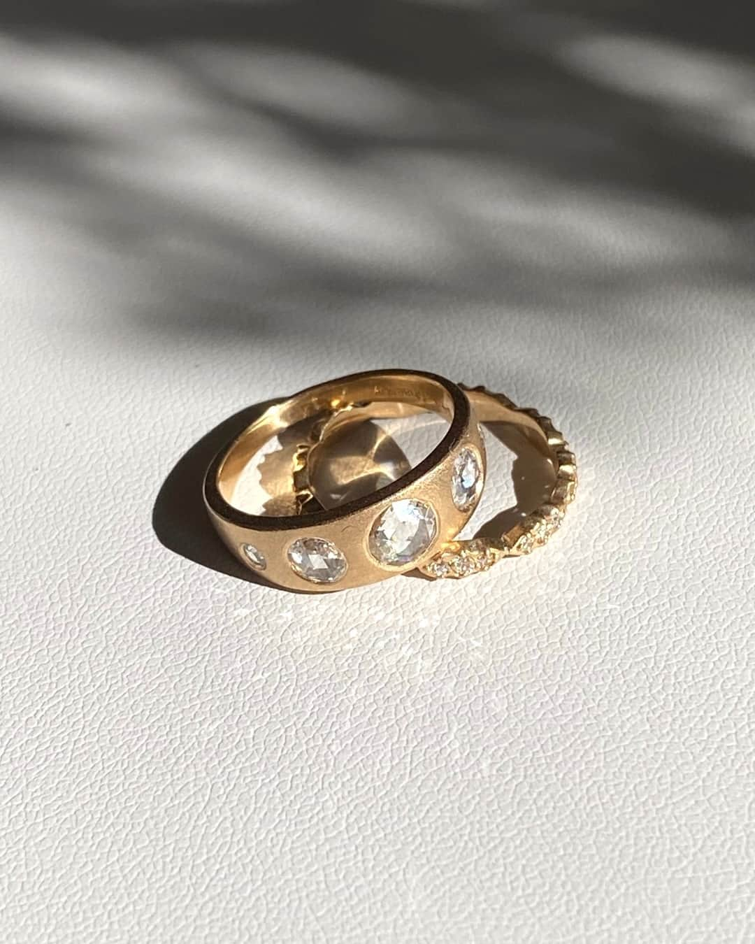 シェイスビーのインスタグラム：「The Rhea and the Wave Stack rings make the perfect pair ✨ Handcrafted with 14k yellow gold encrusted with diamonds, this timeless duo is available now at shaesby.com.⁠」