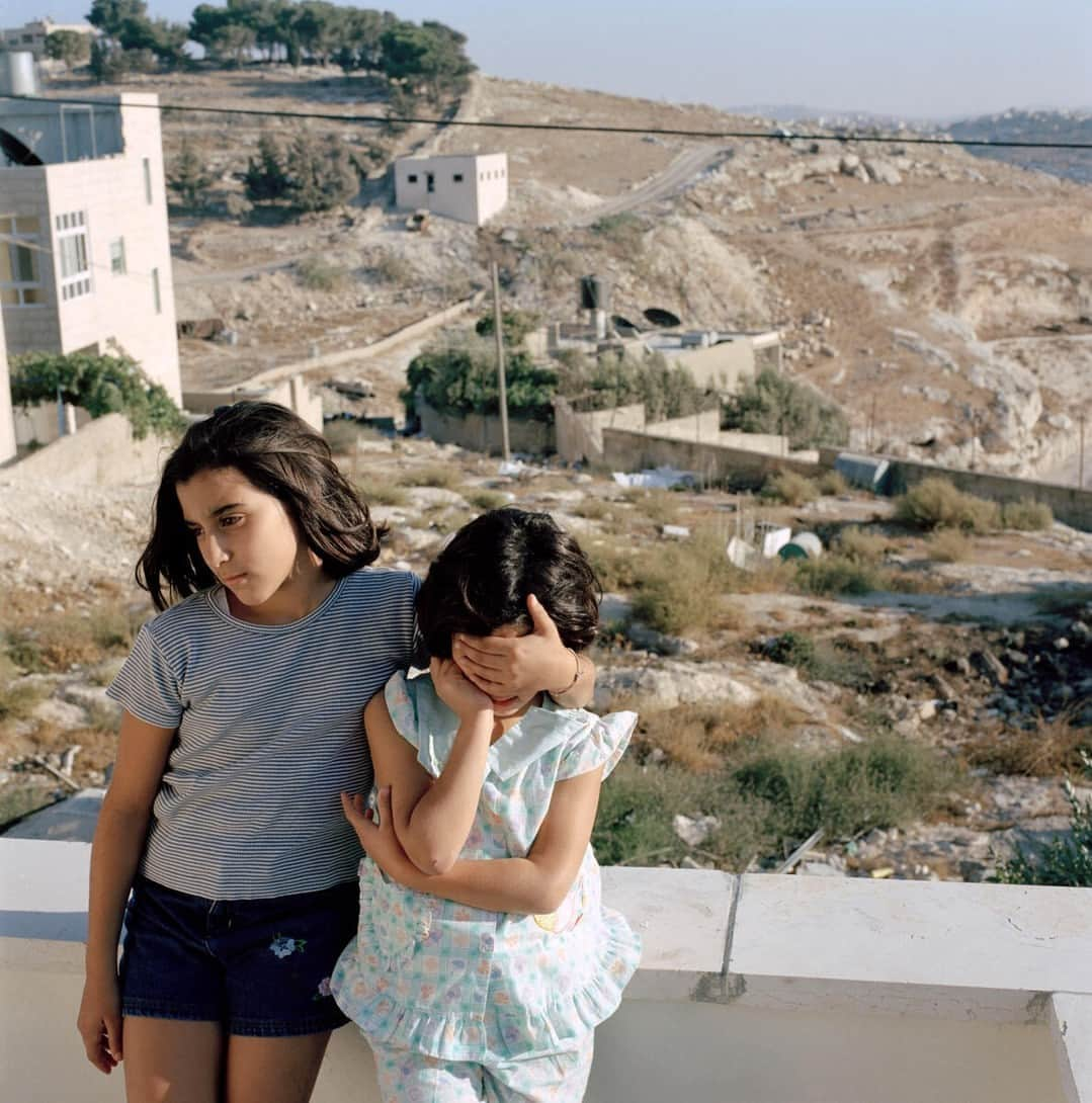 Magnum Photosさんのインスタグラム写真 - (Magnum PhotosInstagram)「@alessandra_sanguinetti: "I first traveled to Palestine in 2003 and 2004, and visited refugee camps in Gaza and Bethlehem. The resulting images document the lives and experiences of young Palestinians growing up amidst the decades long Israeli military occupation, facing daily dangers and human rights violations."⁠ ⁠ Since Hamas launched an unprecedented attack on Israel via the Gaza Strip on Saturday, October 7, killing hundreds of civilians, Israel has dropped more than 1,000 tons of bombs and 2,000 unspecified weapons, so far killing around 600 people, including 78 children, and wounding thousands, according to the Gaza Health Ministry. The U.N. humanitarian agency reports that the strikes have displaced almost 125,000 Palestinians in Gaza.⁠ ⁠ Today, Israel has cut off food, water and fuel from the two million people trapped in Gaza.⁠ ⁠ PHOTOS (left to right): ⁠ ⁠ (1) Separation wall. Abu Dis. 2004. ⁠ ⁠ (2) Zanya and Jasmine overlooking the construction of the separation wall that will isolate them from their town. Abu Dis. 2003. ⁠ ⁠ (3) Riham Khaled Abuheen was shot in the eye by IDF forces during a raid on her building. Shajaiaya. Gaza Strip. 2003. ⁠ ⁠ (4) Landscape. Gaza Strip. 2003. ⁠ ⁠ (5) Hooda next to the door her mom died behind when Israeli soldiers blew through it. Aida refugee camp. 2004.⁠ ⁠ (6) Kids playing. Aida refugee camp. West Bank. 2004. ⁠ ⁠ (7) Schoolgirls. Bethlehem. West Bank. 2003. ⁠ ⁠ (8) Hadir Rizq in a destroyed house. Gaza Strip. 2003. ⁠ ⁠ (9) Schoolgirls looking back at Israel's separation wall and sniper tower. 2003. ⁠ ⁠ © @alessandra_sanguinetti / Magnum Photos」10月10日 4時01分 - magnumphotos