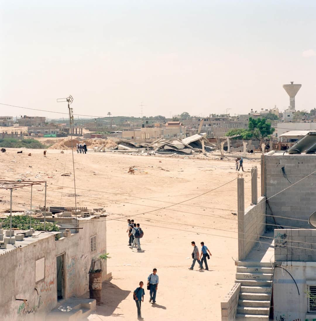 Magnum Photosさんのインスタグラム写真 - (Magnum PhotosInstagram)「@alessandra_sanguinetti: "I first traveled to Palestine in 2003 and 2004, and visited refugee camps in Gaza and Bethlehem. The resulting images document the lives and experiences of young Palestinians growing up amidst the decades long Israeli military occupation, facing daily dangers and human rights violations."⁠ ⁠ Since Hamas launched an unprecedented attack on Israel via the Gaza Strip on Saturday, October 7, killing hundreds of civilians, Israel has dropped more than 1,000 tons of bombs and 2,000 unspecified weapons, so far killing around 600 people, including 78 children, and wounding thousands, according to the Gaza Health Ministry. The U.N. humanitarian agency reports that the strikes have displaced almost 125,000 Palestinians in Gaza.⁠ ⁠ Today, Israel has cut off food, water and fuel from the two million people trapped in Gaza.⁠ ⁠ PHOTOS (left to right): ⁠ ⁠ (1) Separation wall. Abu Dis. 2004. ⁠ ⁠ (2) Zanya and Jasmine overlooking the construction of the separation wall that will isolate them from their town. Abu Dis. 2003. ⁠ ⁠ (3) Riham Khaled Abuheen was shot in the eye by IDF forces during a raid on her building. Shajaiaya. Gaza Strip. 2003. ⁠ ⁠ (4) Landscape. Gaza Strip. 2003. ⁠ ⁠ (5) Hooda next to the door her mom died behind when Israeli soldiers blew through it. Aida refugee camp. 2004.⁠ ⁠ (6) Kids playing. Aida refugee camp. West Bank. 2004. ⁠ ⁠ (7) Schoolgirls. Bethlehem. West Bank. 2003. ⁠ ⁠ (8) Hadir Rizq in a destroyed house. Gaza Strip. 2003. ⁠ ⁠ (9) Schoolgirls looking back at Israel's separation wall and sniper tower. 2003. ⁠ ⁠ © @alessandra_sanguinetti / Magnum Photos」10月10日 4時01分 - magnumphotos