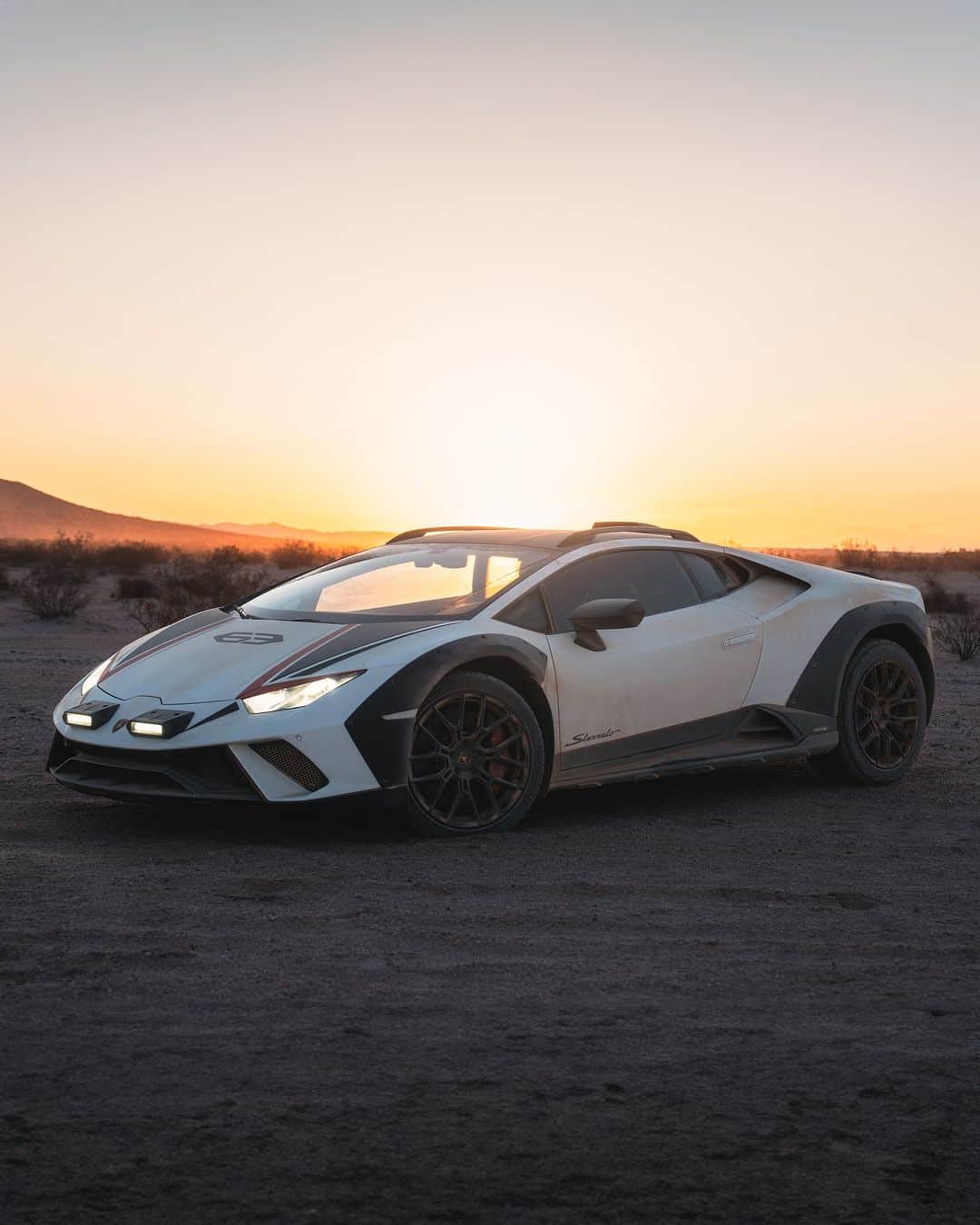 ランボルギーニのインスタグラム：「Follow the setting sun with Huracán Sterrato's Rally mode, embarking on a genuine adventure that transcends all boundaries. Embrace the thrill of venturing into the unknown!  #Lamborghini #HuracanSterrato #BeyondTheConcrete __ Huracán Sterrato: fuel consumption combined: 14,9 l/100km (WLTP); CO2-emissions combined: 337 g/km (WLTP)」