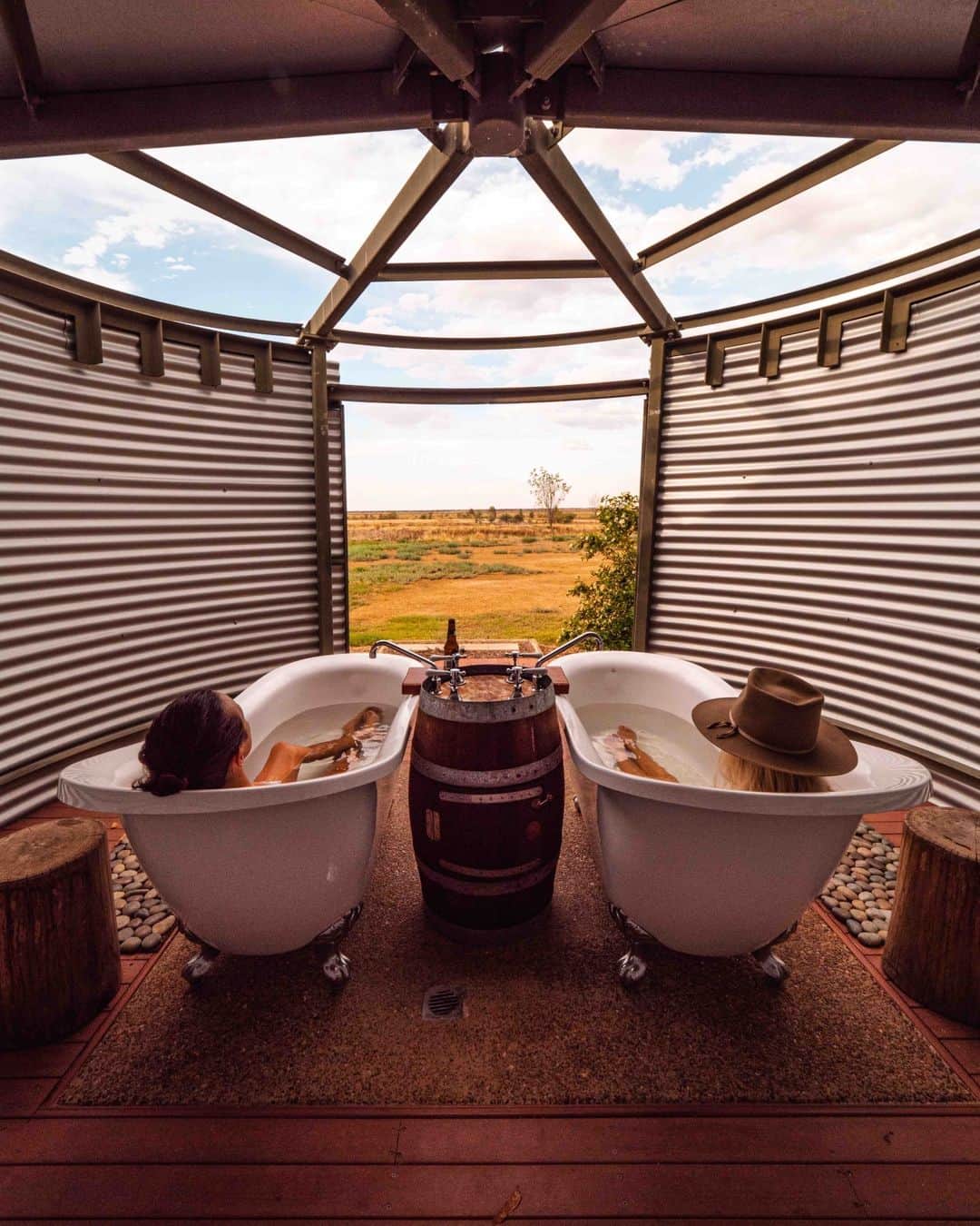 Australiaさんのインスタグラム写真 - (AustraliaInstagram)「Soaking up the serenity of @outbackqueensland 🛀. Definitely not your everyday bubble bath, these luxe tubs offer more than just picture-perfect sunsets 🌅 Set on the property of @jcvanpark in @queensland, their soothing warm water is drawn from 900m below the ground, with nutrient-rich minerals that are said to have healing powers. Tip: weave your way through the iconic #Aussie outback via a picturesque #roadtrip starting from @townsvillenorthqueensland to reach Julia Creek Artesian Baths 🤠   #SeeAustralia #ComeAndSayGday #ThisIsQueensland #OutbackQueensland.  ID: A man and woman laying in twin outdoor bath tubs with a view of blue skies and countryside.」10月12日 4時00分 - australia