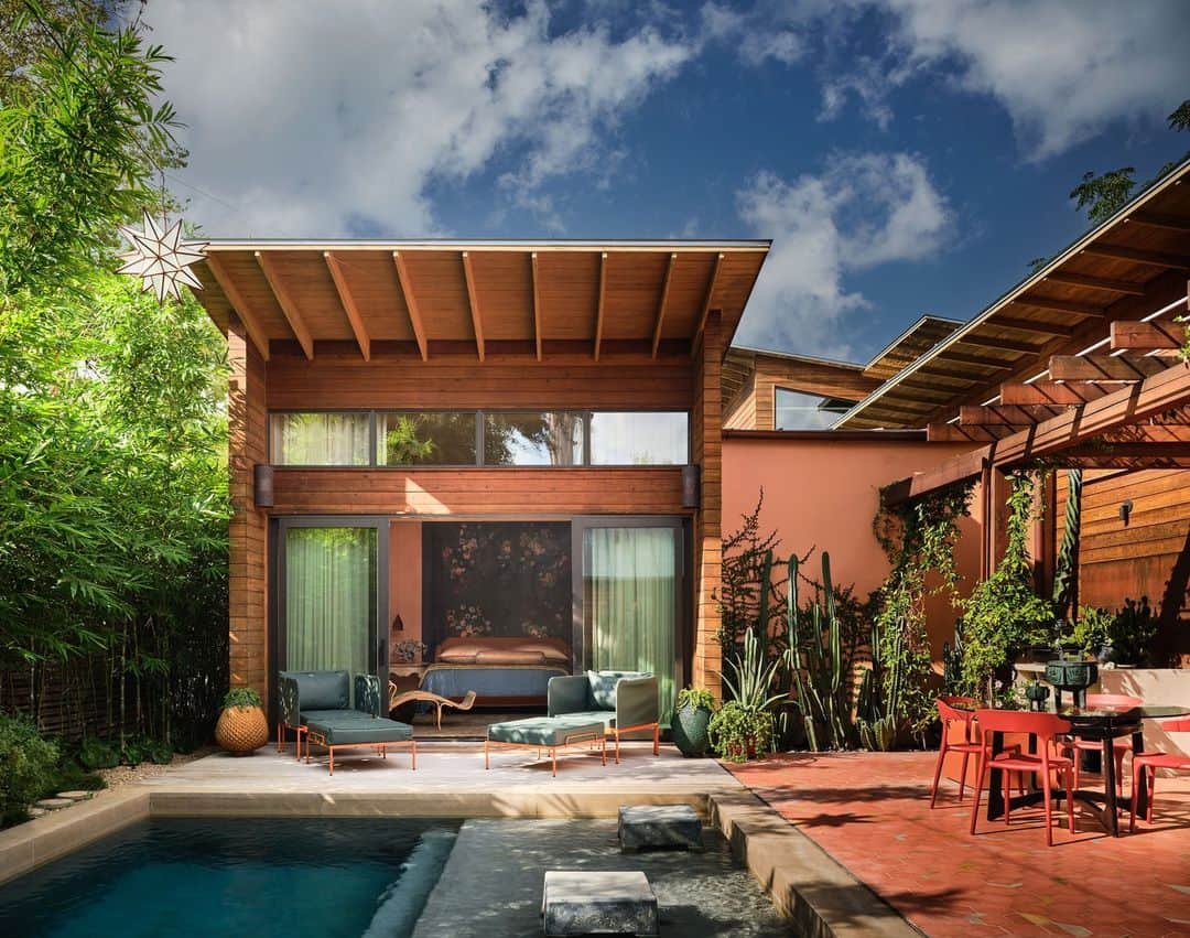 のインスタグラム：「What if paradise was right in your backyard? That’s the case with this San Antonio home which—behind its historic facade–conceals a modern extension, not to mention the ultimate staycation. The courtyard was recently redesigned by architect Vicki Yuan of @lakeflato and includes a new pool (complete with its own water feature), a pergola, and outdoor grilling and dining areas. The same tile that clads the kitchen island also appears on the terrace, “so the island of the kitchen kind of almost becomes a swim-up bar,” Yuan says. Just add palomas and we’re there!   Click the link in bio for the full tour of this eclectic Texas home. Written by @anna_fixsen. Photographed by @douglasfriedman. Styled by @jennyoconnorstudio.」
