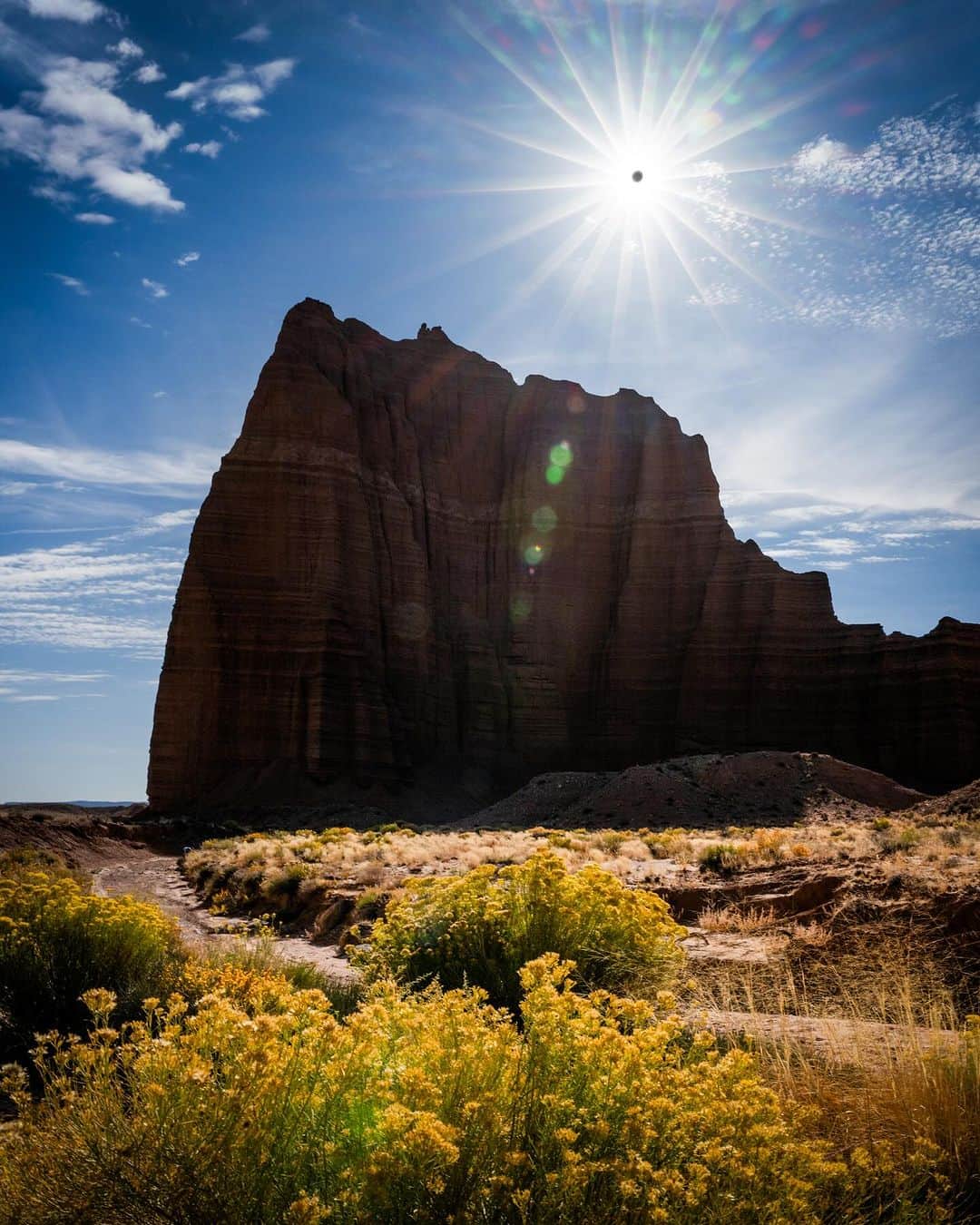 Travis Burkeのインスタグラム：「This morning's ‘Ring Of Fire’ Solar Eclipse above the Temple of the Sun in Utah.  I blended multiple exposures to show both the landscape and the moon passing entirely in front of the sun, as the combination of both made the experience more beautiful for me.   Capturing different celestial events is always fun and challenging, and I learn a lot each time.   I fell in love with photography because it got me into nature more frequently and made me appreciate the beauty around me. The same is true today and is ultimately why I’ve just committed to massive changes in my life that I am excited to share soon.  I hope you got to witness this eclipse or get the opportunity sometime in the future!  #ringoffireeclipse #solareclipse」