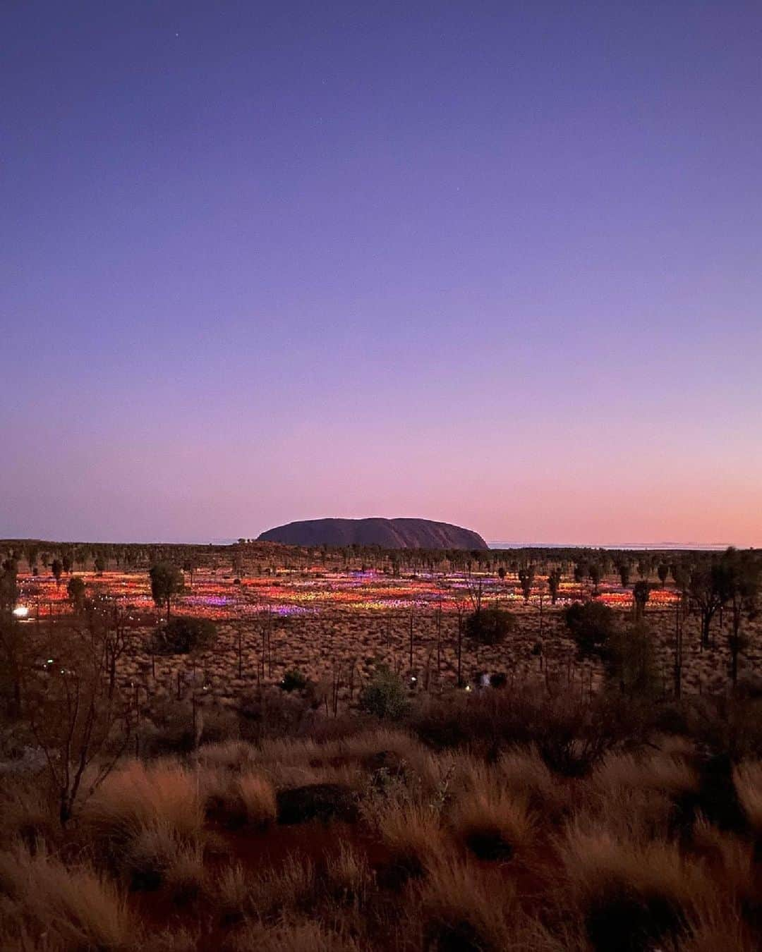 Australiaさんのインスタグラム写真 - (AustraliaInstagram)「You're positively glowing, @exploreuluru 🌟 Captured here by @beyond_kristy, you're looking at the spectacular #FieldofLight, an outdoor exhibition by @brucemunrostudio that lights up @ntaustralia's #UluṟuKataTjuṯaNationalPark at sunset. Planning a business event in this stunning part of @visitcentralaus? @exploreuluru's Wintjiri Wiṟu and #TaliWiru are also not to be missed!  #ComeAndSayGday #SeeAustralia #NTAustralia #VisitCentralAustralia #MeetInAus @ntbusinessevents  ID: Uluṟu stands proudly against a purple sunset sky. Colourful lights dot the rugged desert landscape in the foreground.」10月16日 4時00分 - australia