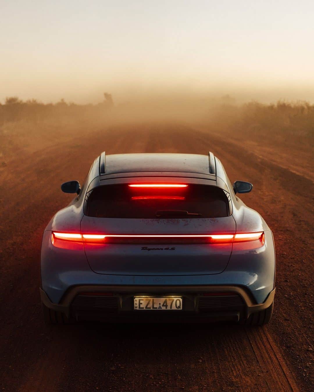 Porscheのインスタグラム：「Covered in the dust of its 5,000km outback adventure, the Taycan 4S Cross Turismo finally arrives on Australia's east coast. Join a host of vibrant Porsche personalities as they navigate the world's oldest continent in the all-electric five-seater, pushing the car to its limit. Link in bio. __ Taycan 4S Cross Turismo: Electrical consumption combined: 24.8 – 21.4 kWh/100 km (WLTP); CO₂ emissions combined: 0 g/km (WLTP); Electric range: 415 – 488 km; Electric range City: 517 – 598 km  I https://porsche.click/DAT-Leitfaden I Status: 10/2023」
